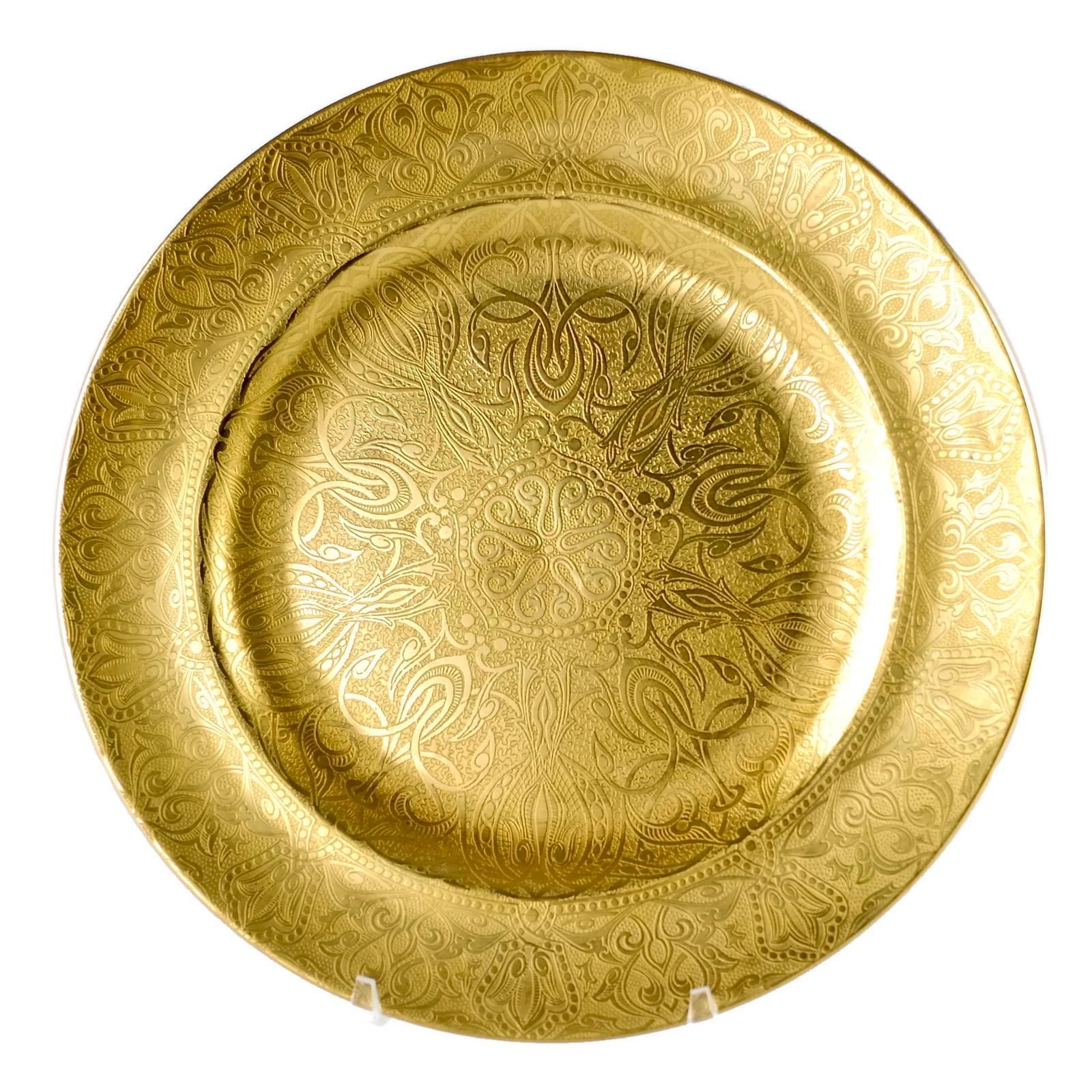 This rare set of 12 English porcelain presentation plates was made by Crown Staffordshire and features heavy gilt decoration. The pieces have an intricate pattern consisting of a central medallion surrounded by arabesque elements, all of which are