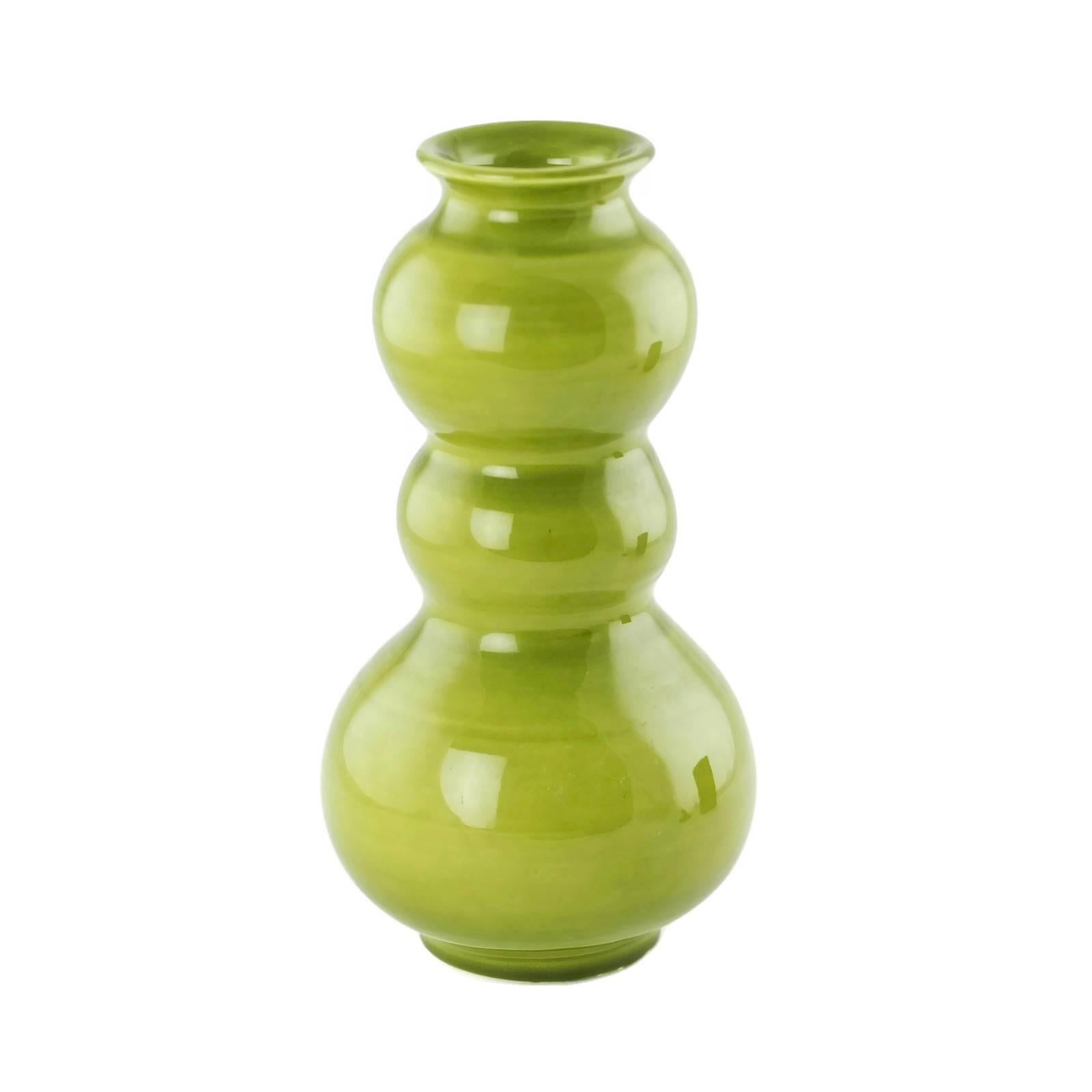 This striking ceramic vase is by noted Italian designer Alvino Bagni (1919-2000) and was made in Italy for American importer Raymor. The piece has a triple gourd form and is finished in a bright lime green glaze. The underside of the piece is signed