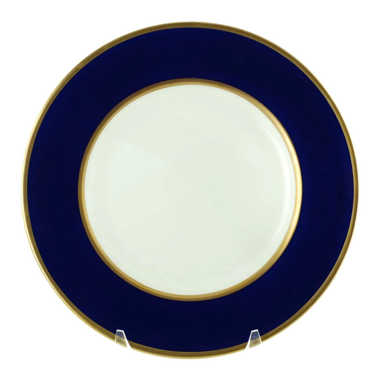 This elegant set of 18 Wedgwood bone china service/dinner plates feature cobalt blue bands trimmed in gilt. The Classic combination of blue and gold coordinates well with a myriad of patterns produced by Wedgwood or other fine bone china