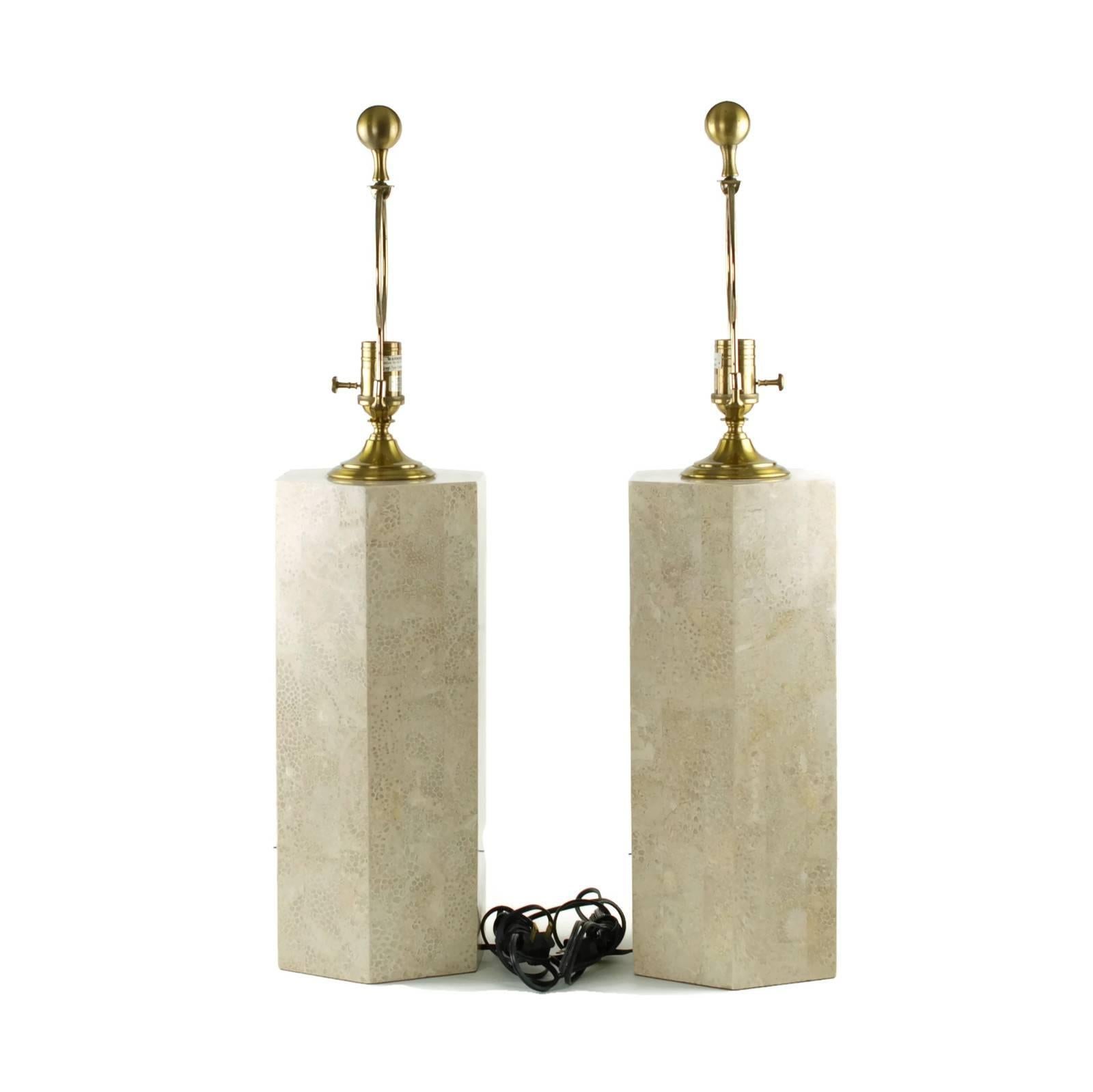 This matched pair of elegant table lamps was made by Wildwood of North Carolina. The lamps have a columnar hexagonal form and feature tessellated mosaic decoration with brass trim. The tessellated portion of the lamps stand 16