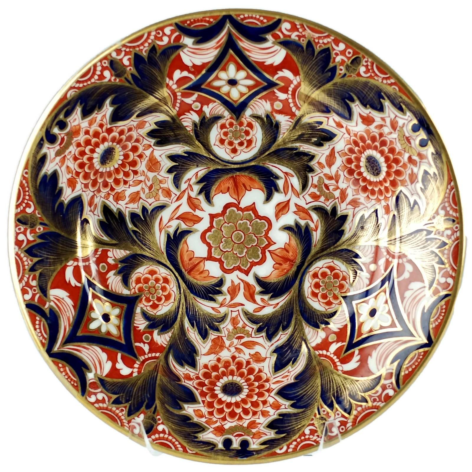 These English porcelain plates are decorated in an ornate Imari pattern and were made by Derby at their Nottingham Road factory, which was in operation from 1756-1848. The manufactory was granted the right by George II to use the crown as part of