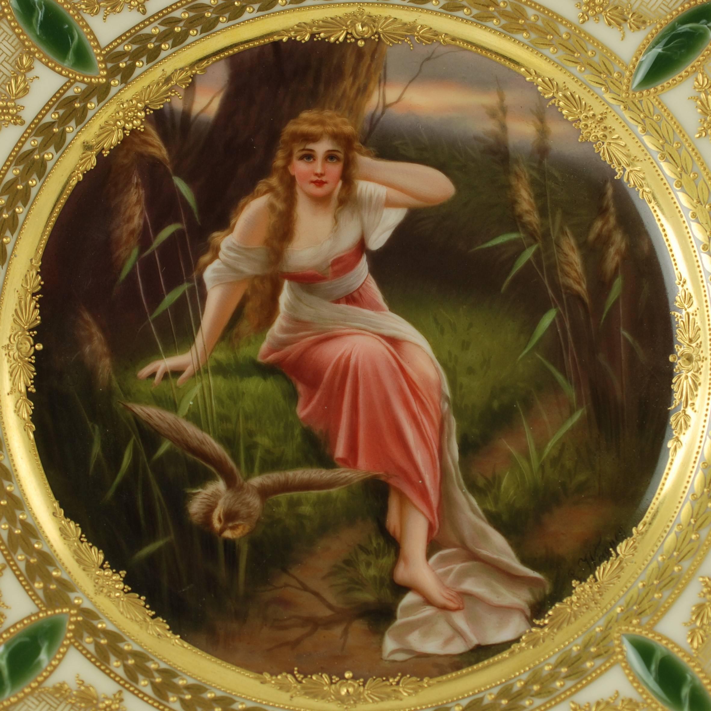 This beautifully decorated 19th century hand-painted Royal Vienna Porcelain cabinet plate is titled Märchen which translates from German as Fairy Tale. The piece has been signed by Wagner and depicts a forest scene featuring a young woman seated on