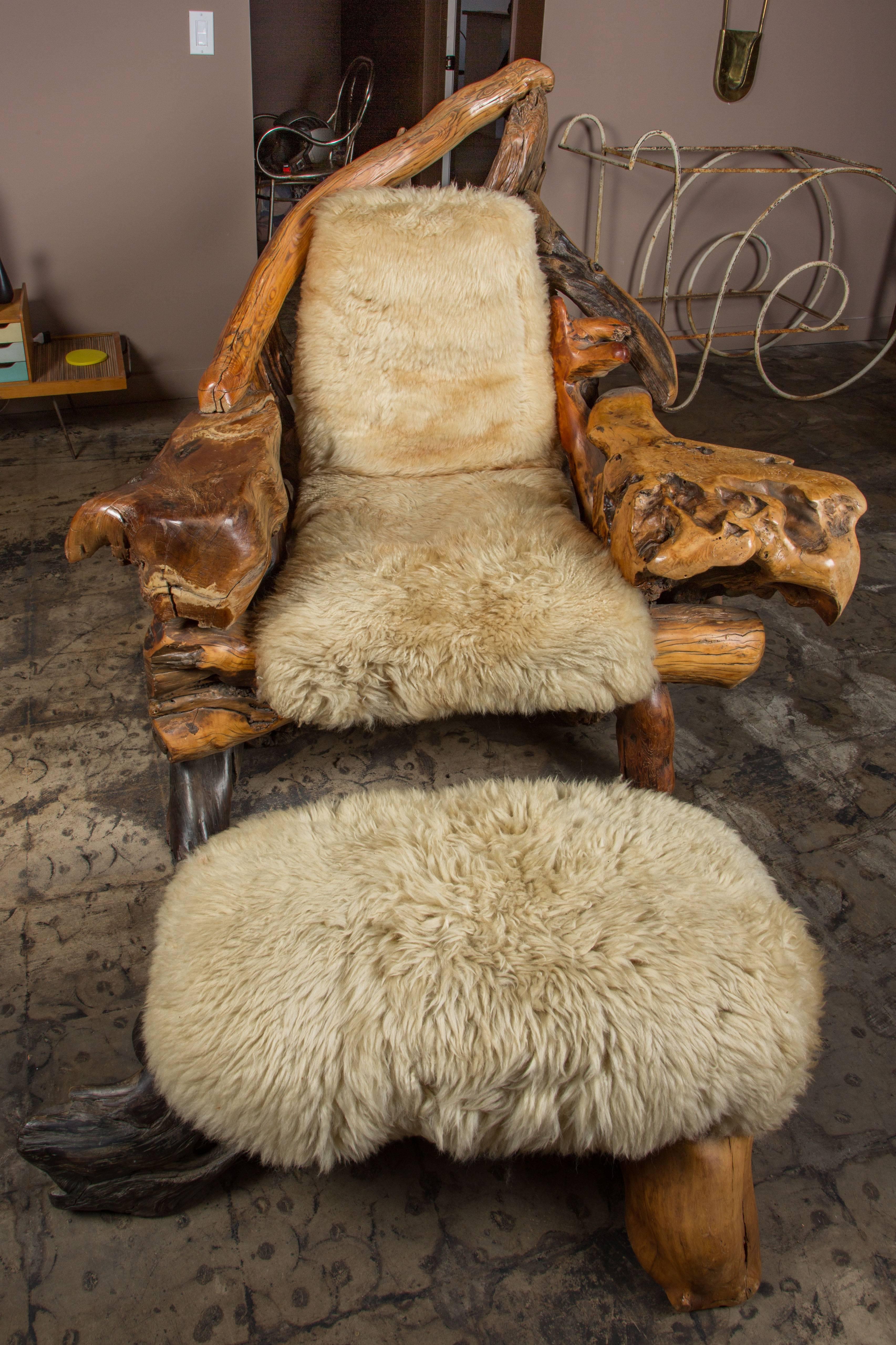 Throne like, handcrafted organic burl wood lounge chair and ottoman with sheepskin upholstery and pillow. Made in California, circa 1960s.

Ottoman measures 35" W x 16" D x 15" H.