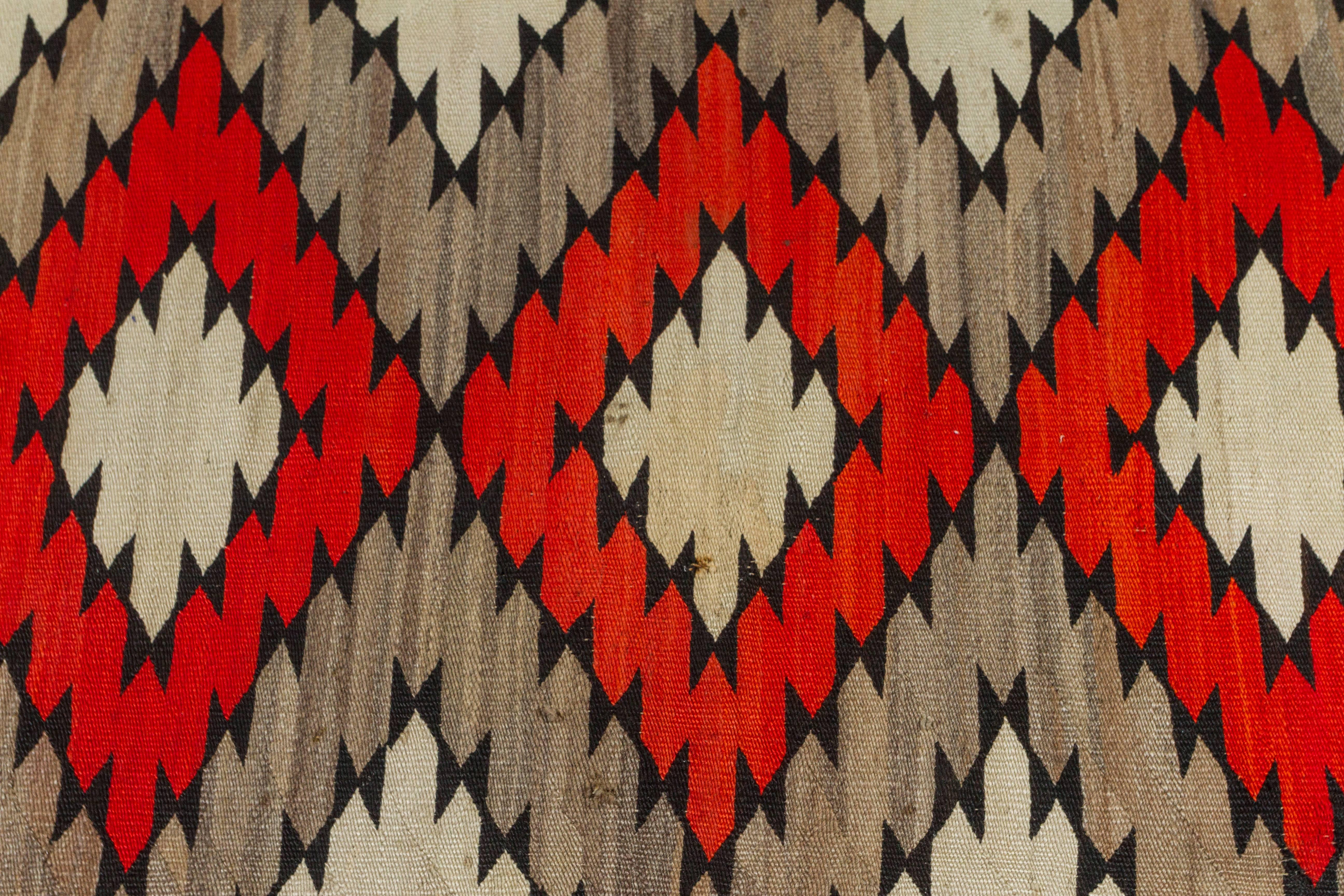 Naturally dyed wool eyedazzler Navajo blanket/rug. Made in North America circa 1920s.