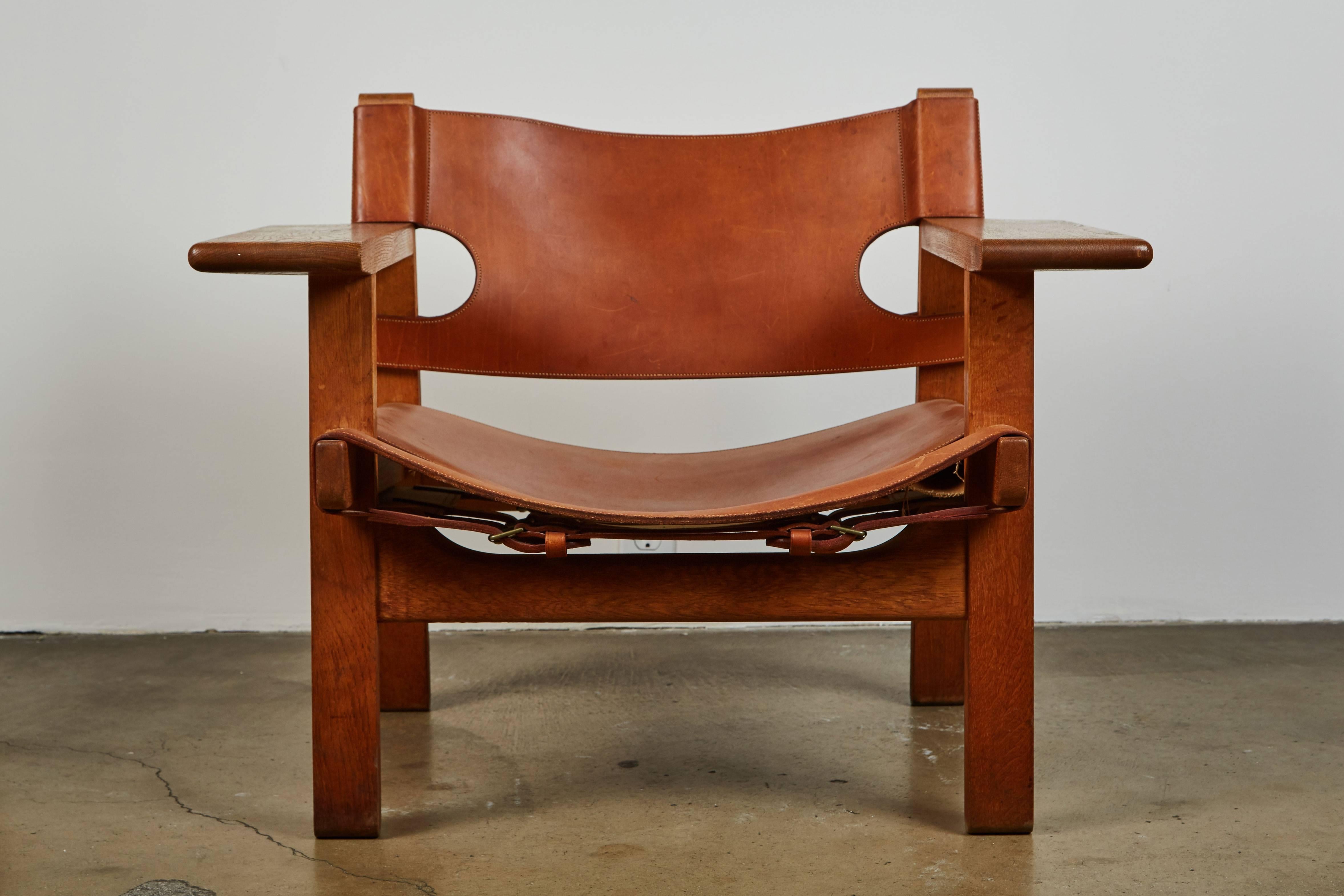 Iconic pair of early Spanish chairs by Børge Mogensen for Fredericia Furniture. Solid oak and beautiful patinated cognac leather. Made in Denmark, circa 1958.