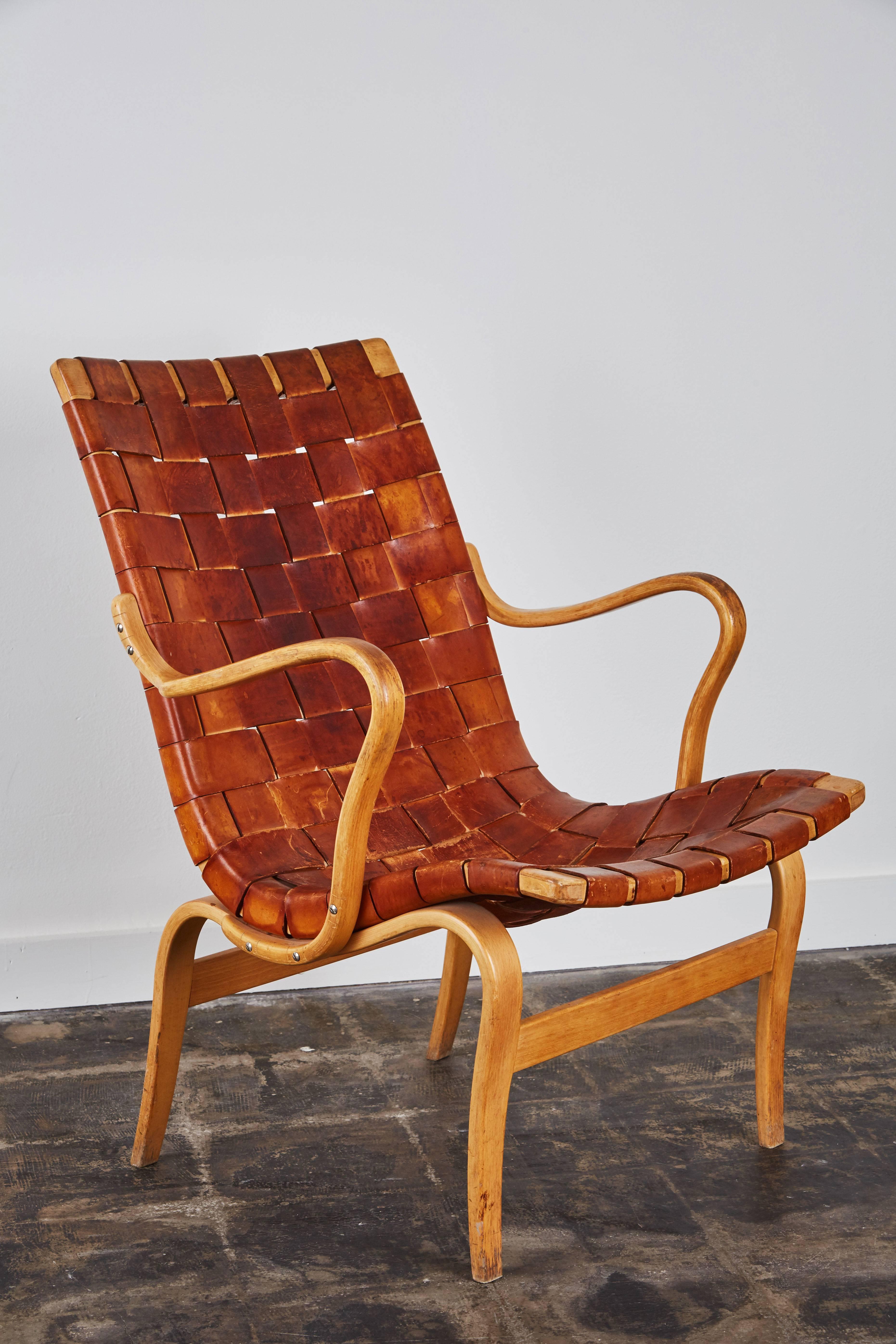 Pair of patinated leather armchairs by Bruno Mathsson for Karl Mathsson. Made in Sweden, circa 1960s.

Signed with branded manufacturer's marks to stretcher.