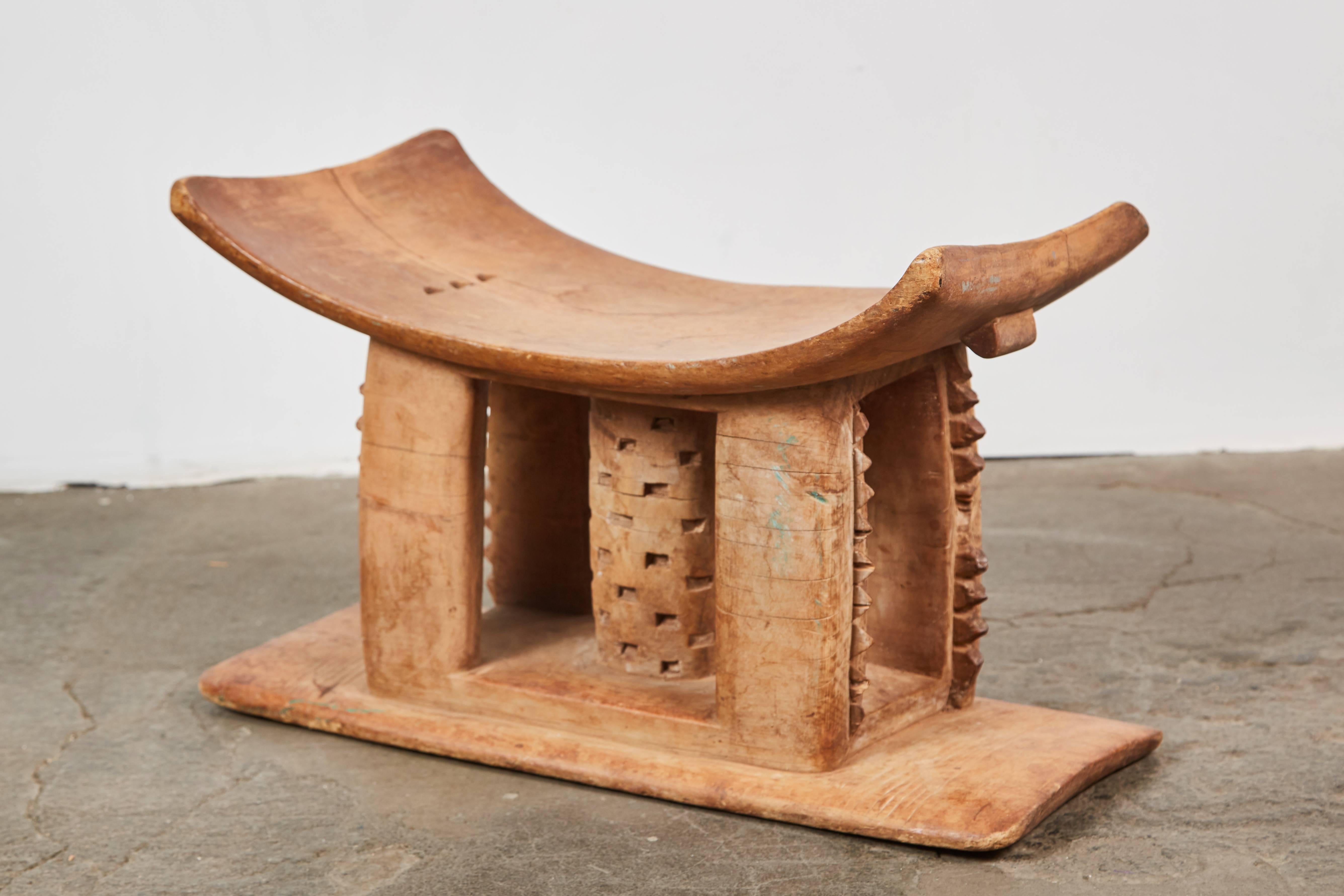 Elaborate hand-carved wood Ashanti stool. Made in Ghana, circa early 20th century.