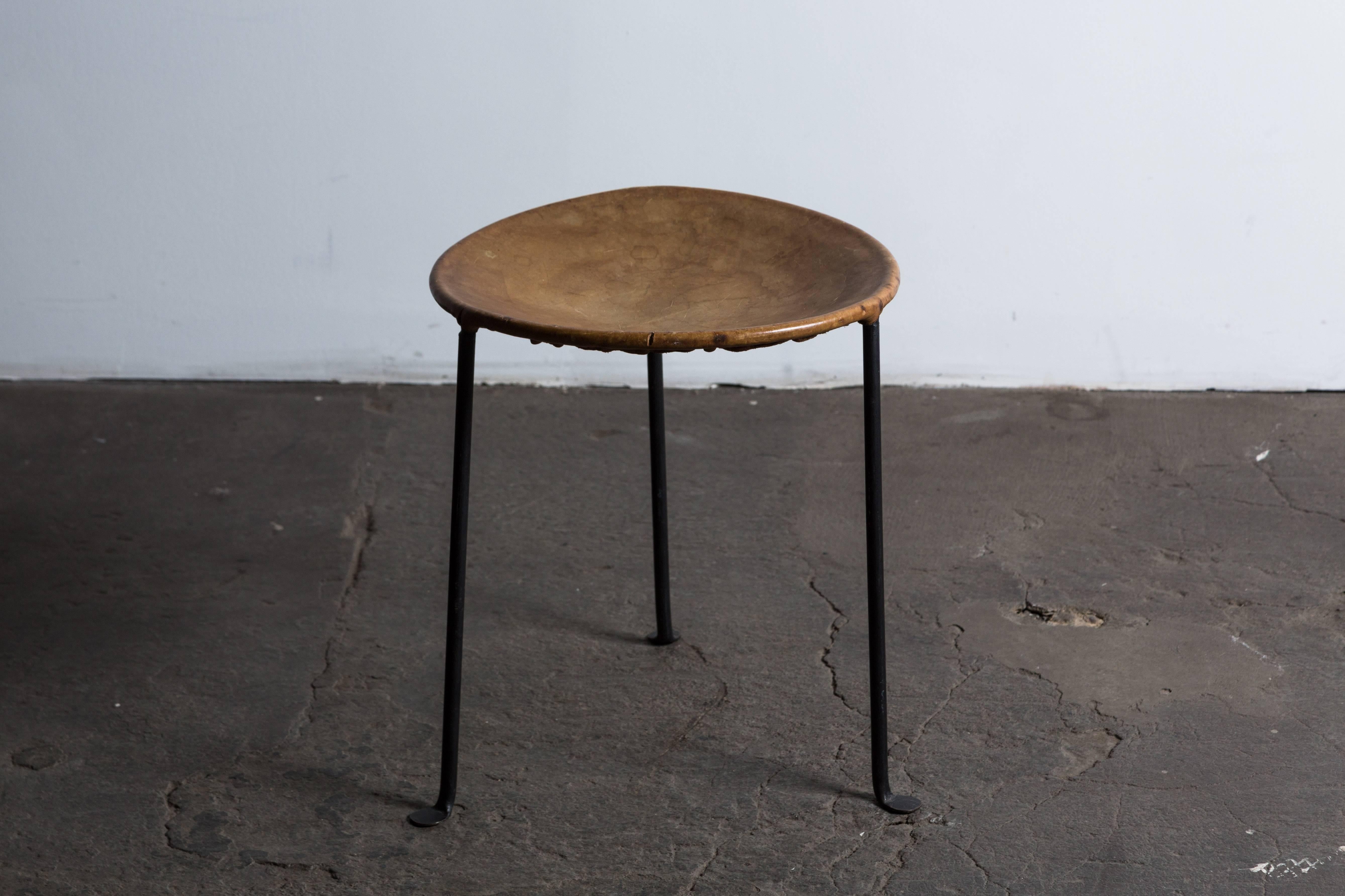 Hand-wrought iron stool with patinated leather seat by Lila Swift and Donald Monell. Made in USA, circa 1950s.