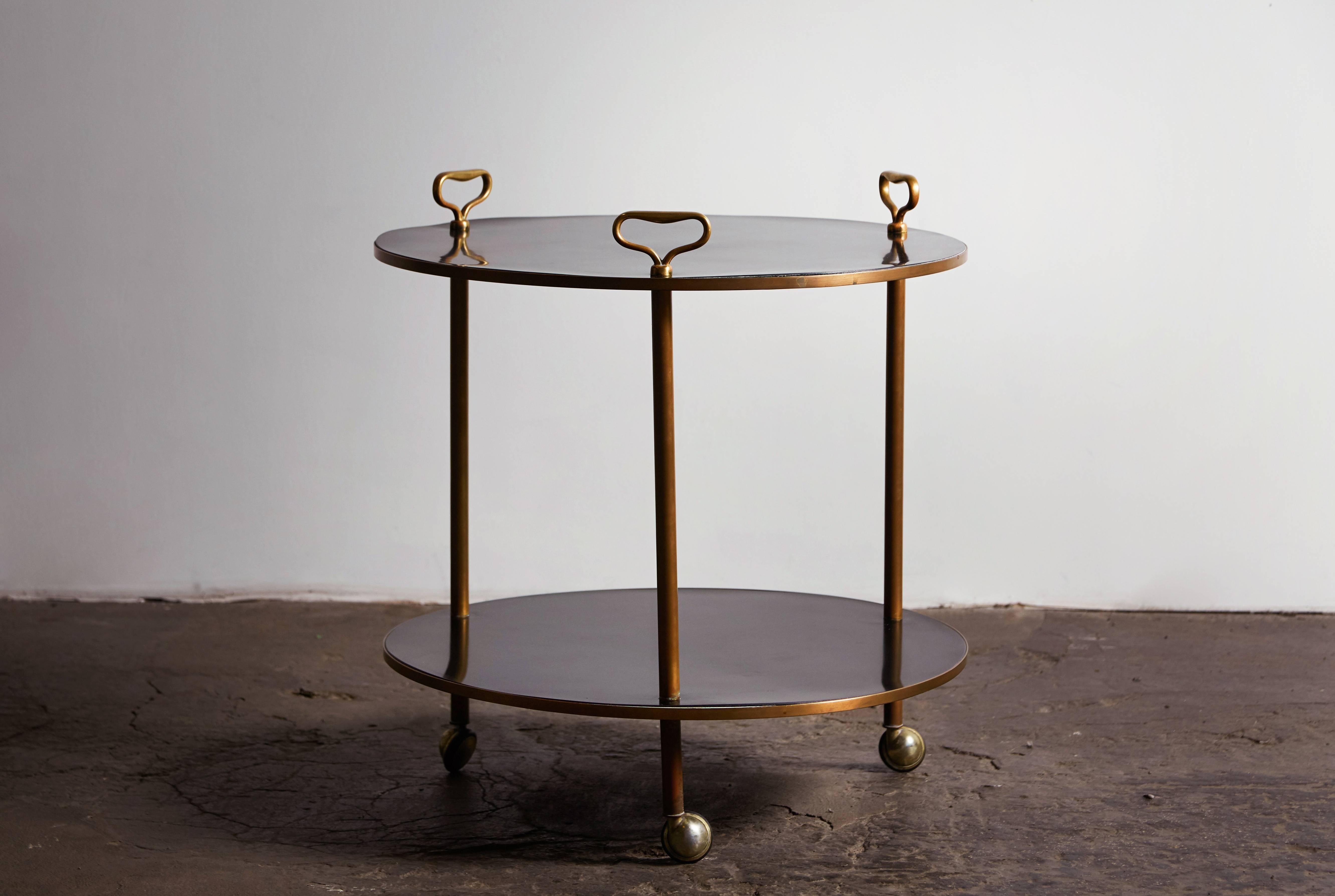 Rare brass and laminate two-tier rolling table by Corrado Corradi Dell’Acqua for Azucena. Made in Italy, circa 1953.