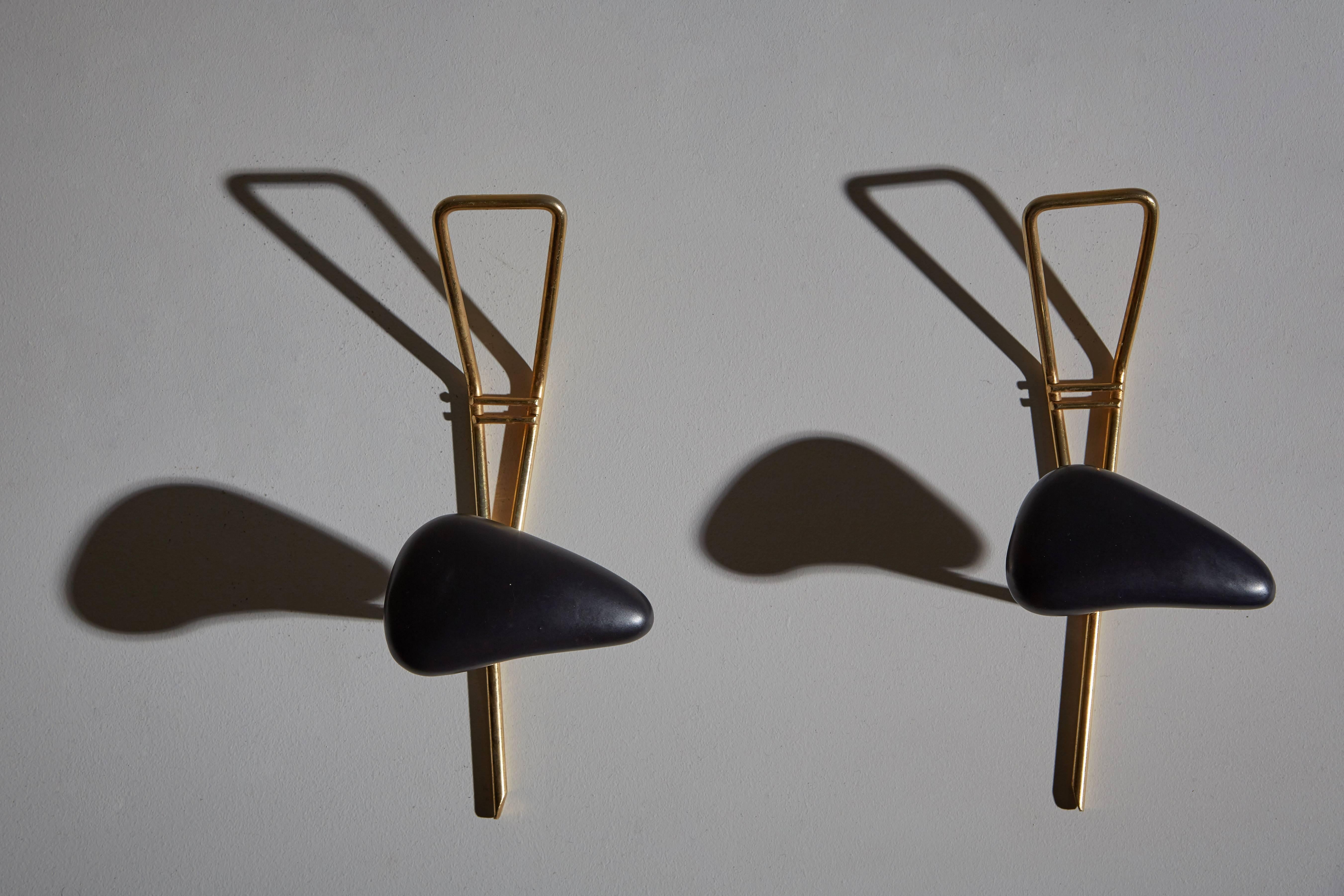 Pair of ceramic and brass wall-mounted coat racks by Georges Jouve for Marcel Asselbur. Made in France, circa 1950s.