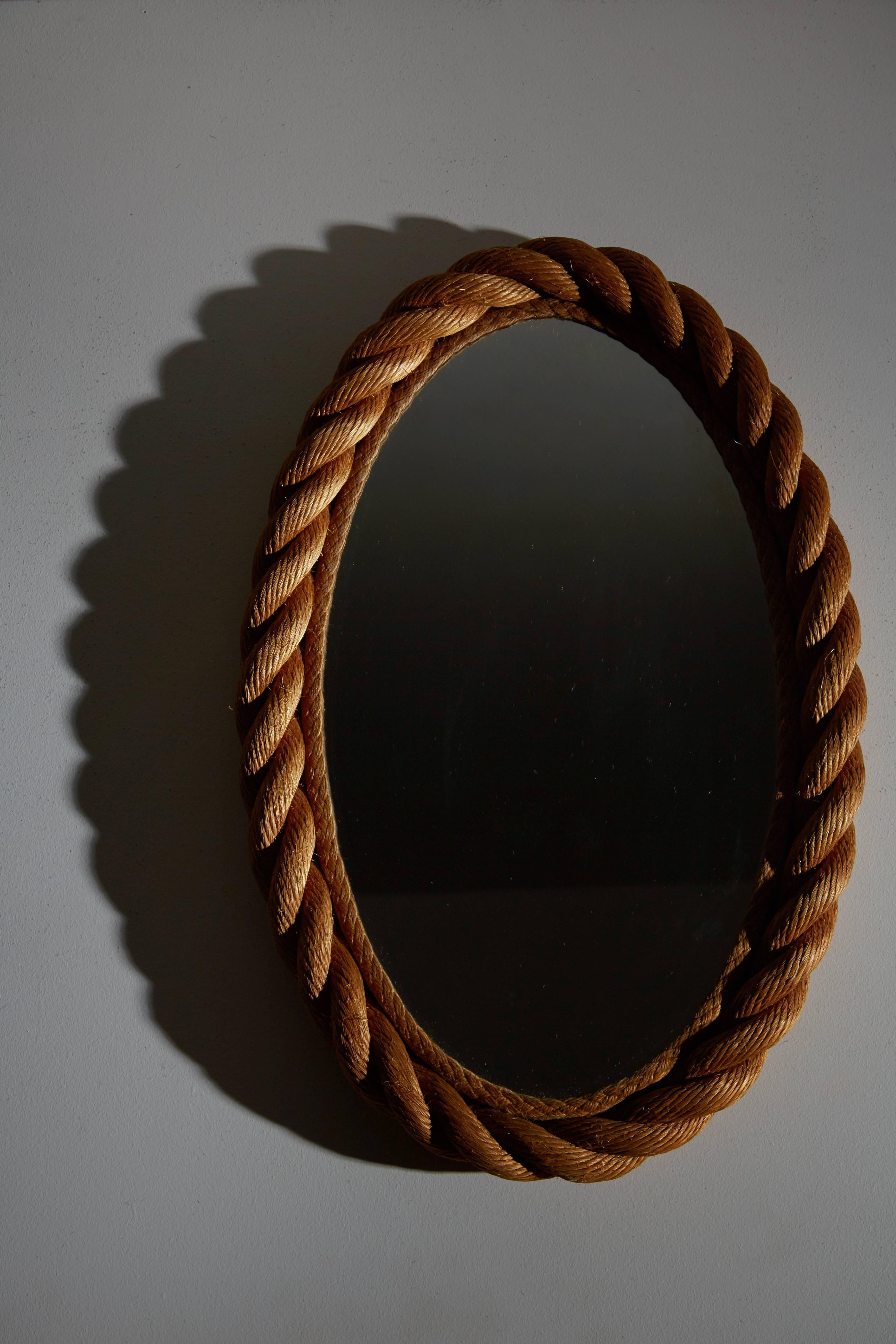 Oval rope mirror by Audoux Minet. Simple frame made of woven abaca in Golfe-Juan, France, circa 1950s.