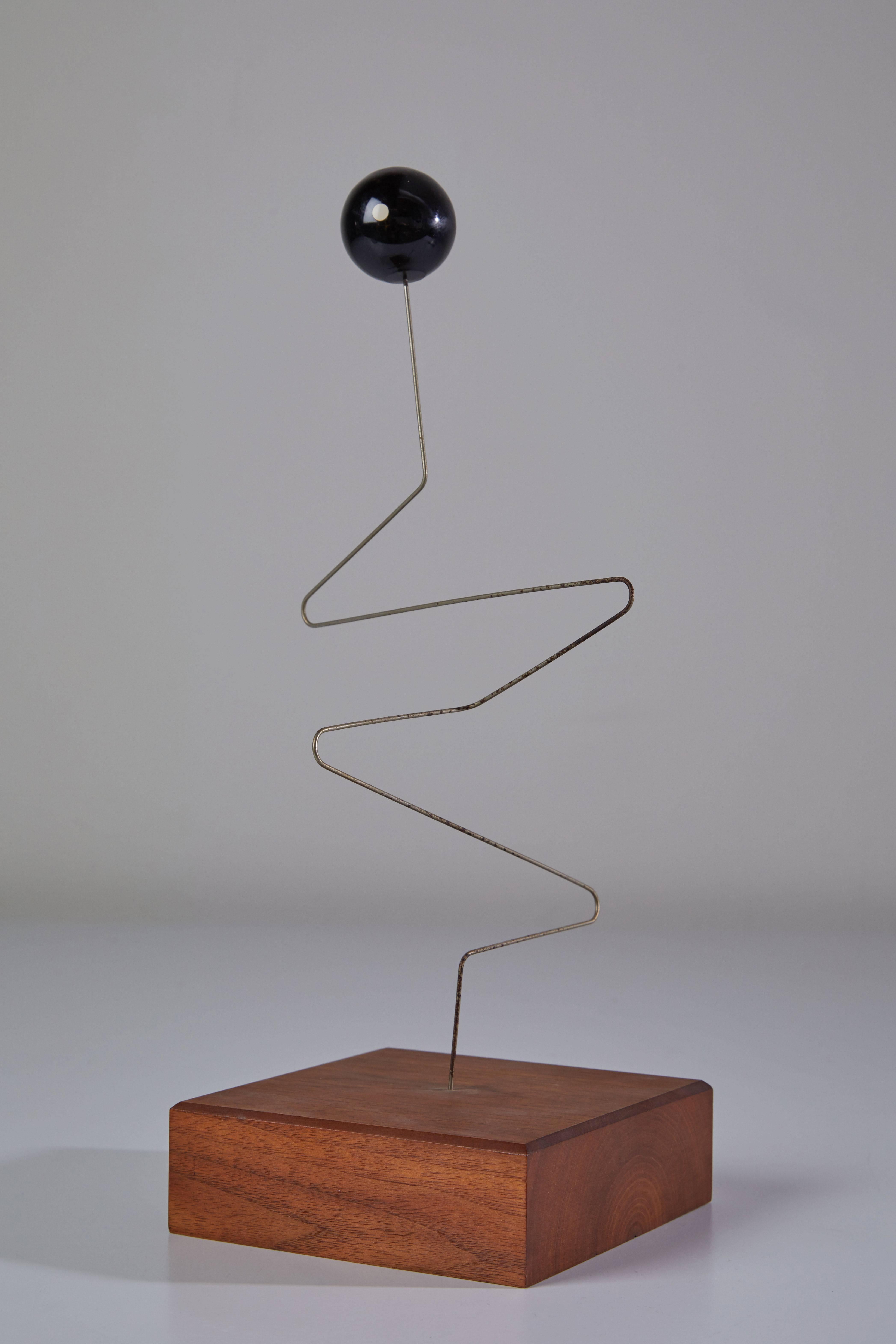 Modernist Kinetic sculpture with wood base. Made in USA, circa 1950s.