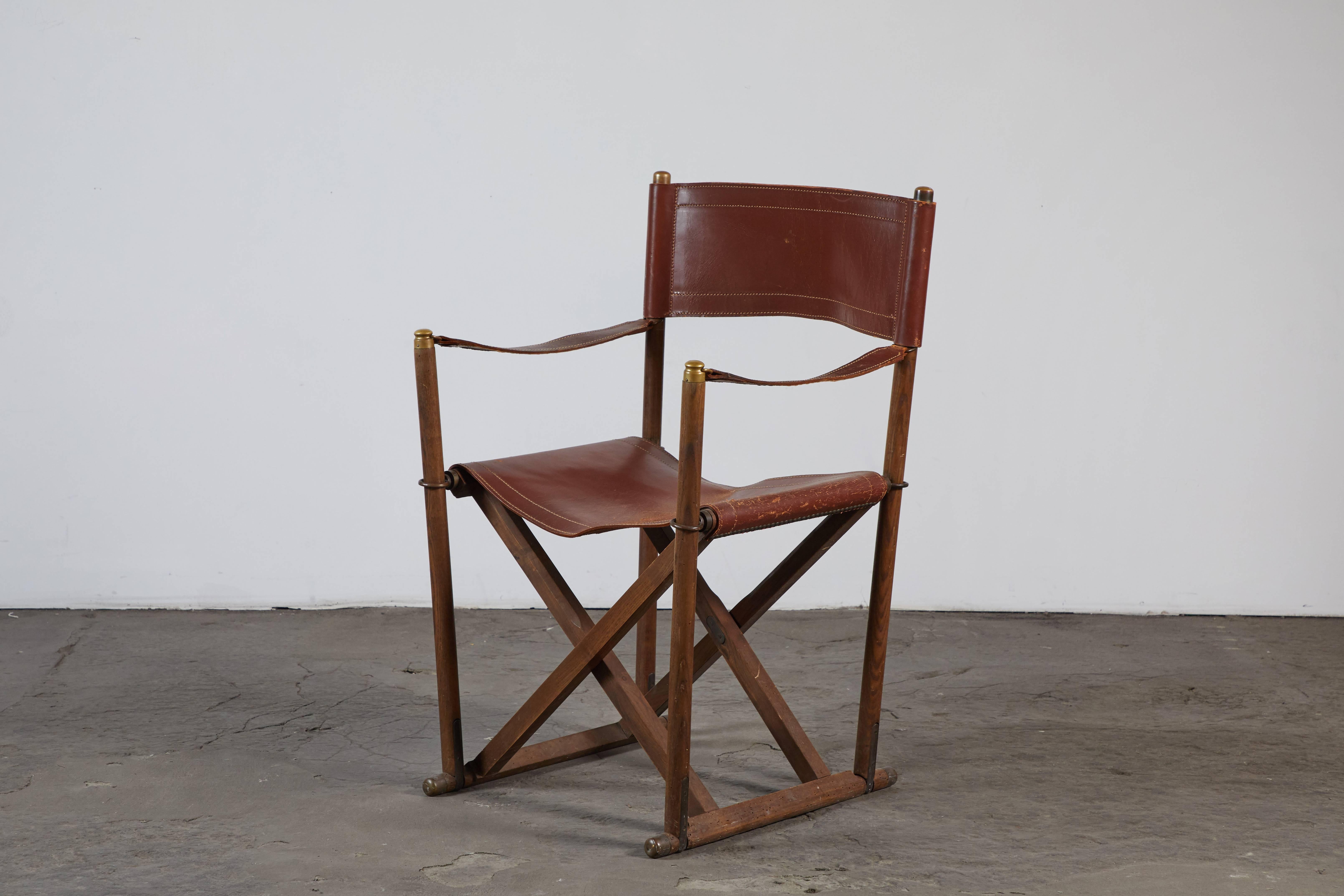 Early patinated leather MK-16 folding Campaign safari chair by Mogens Koch. Made in Denmark, circa 1930s.
 