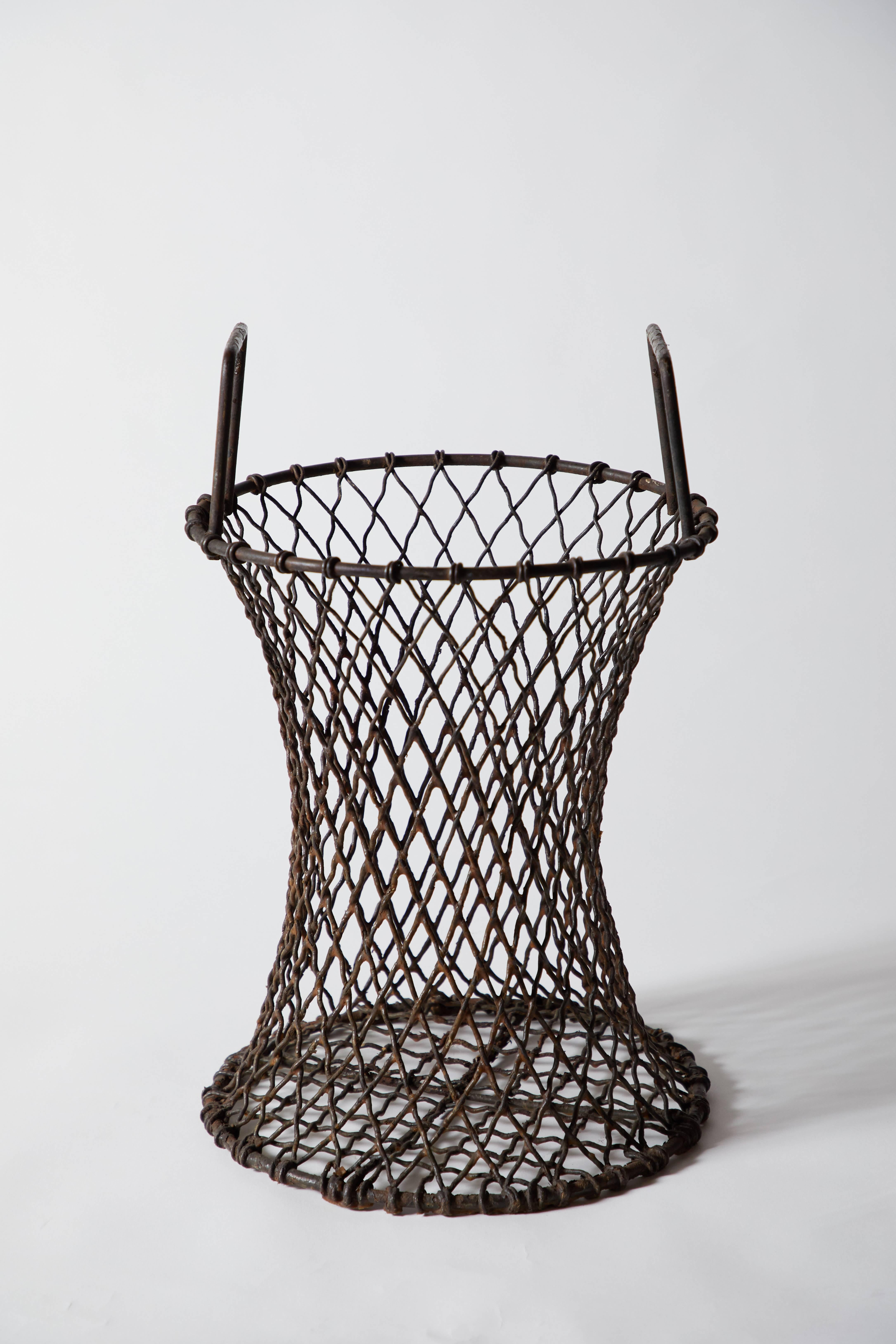 Early 20th century sculptural iron basket/umbrella stand with handles. Made in USA, circa 1900s.