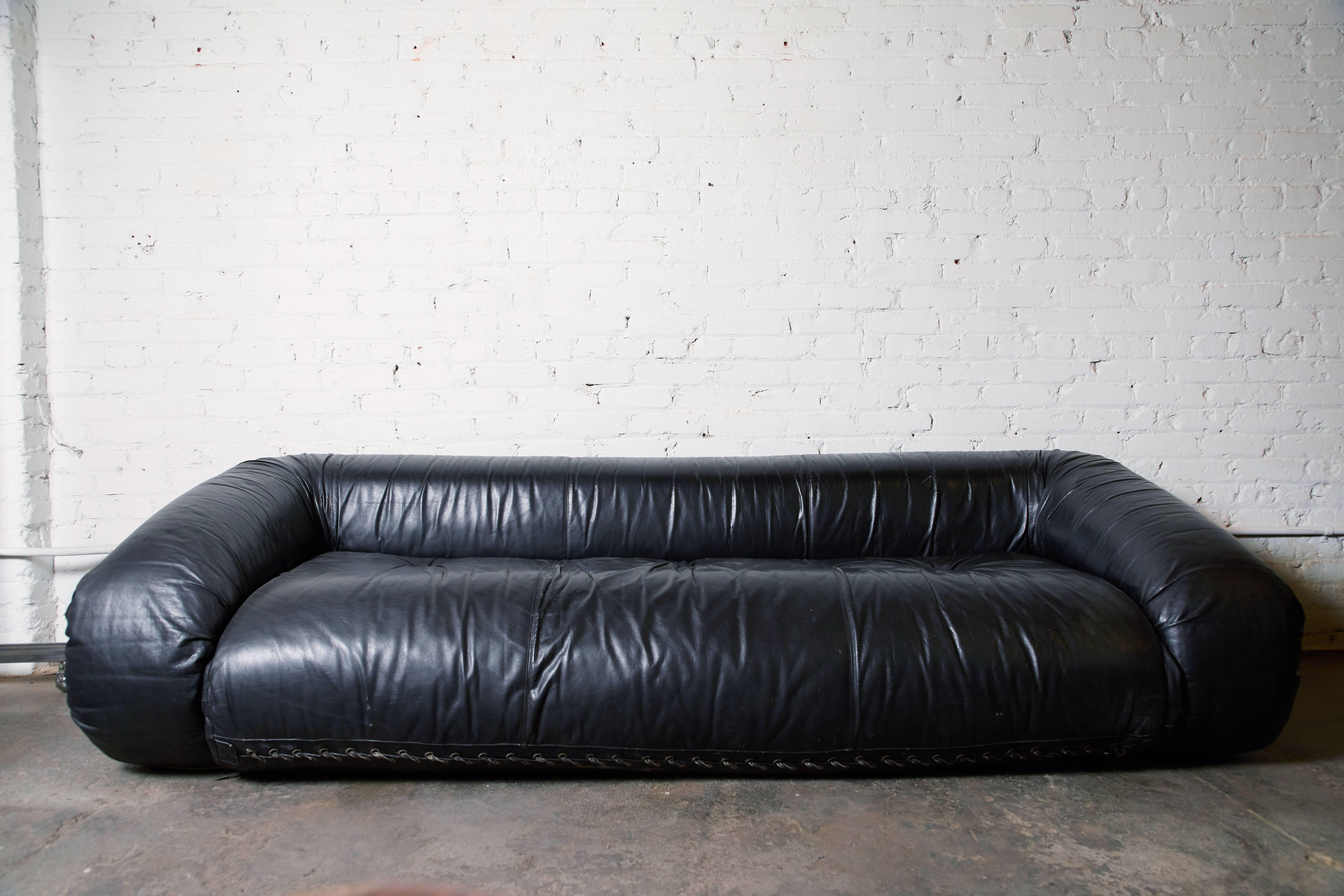Iconic leather “Anfibio” convertible sofa bed by Alessandro Becchi for Giovannetti, circa 1970s. Bed with sheepskin cover measures approx. 91