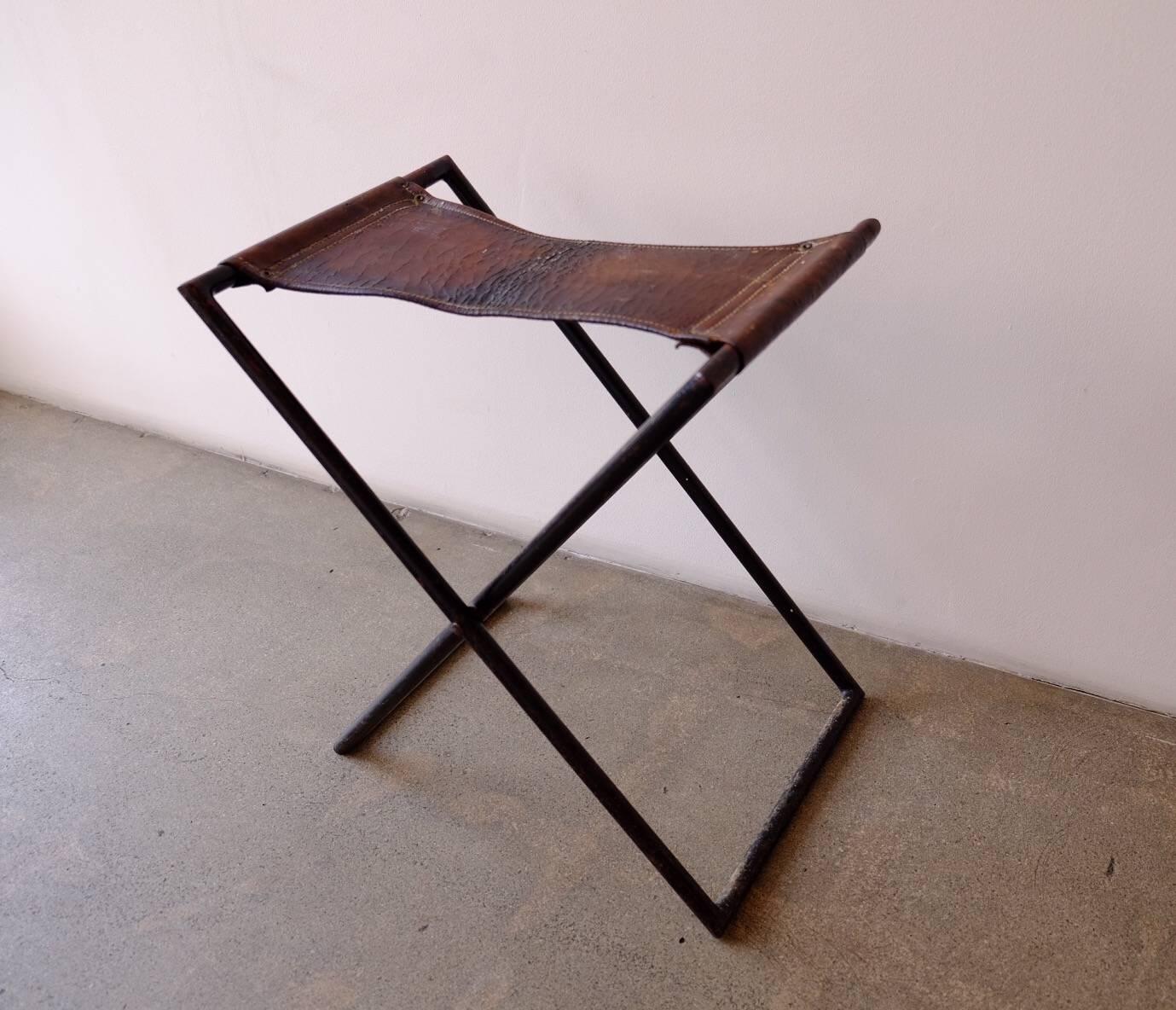 Distressed leather and iron folding/camping stool. Made in France, circa 1950s.