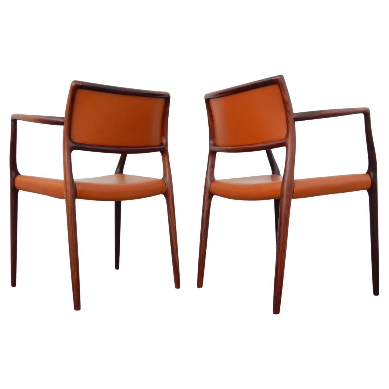Mid-20th Century 8 Danish Modern Niels Otto Møller Sculpted Rosewood Dining Arm Chairs For Sale