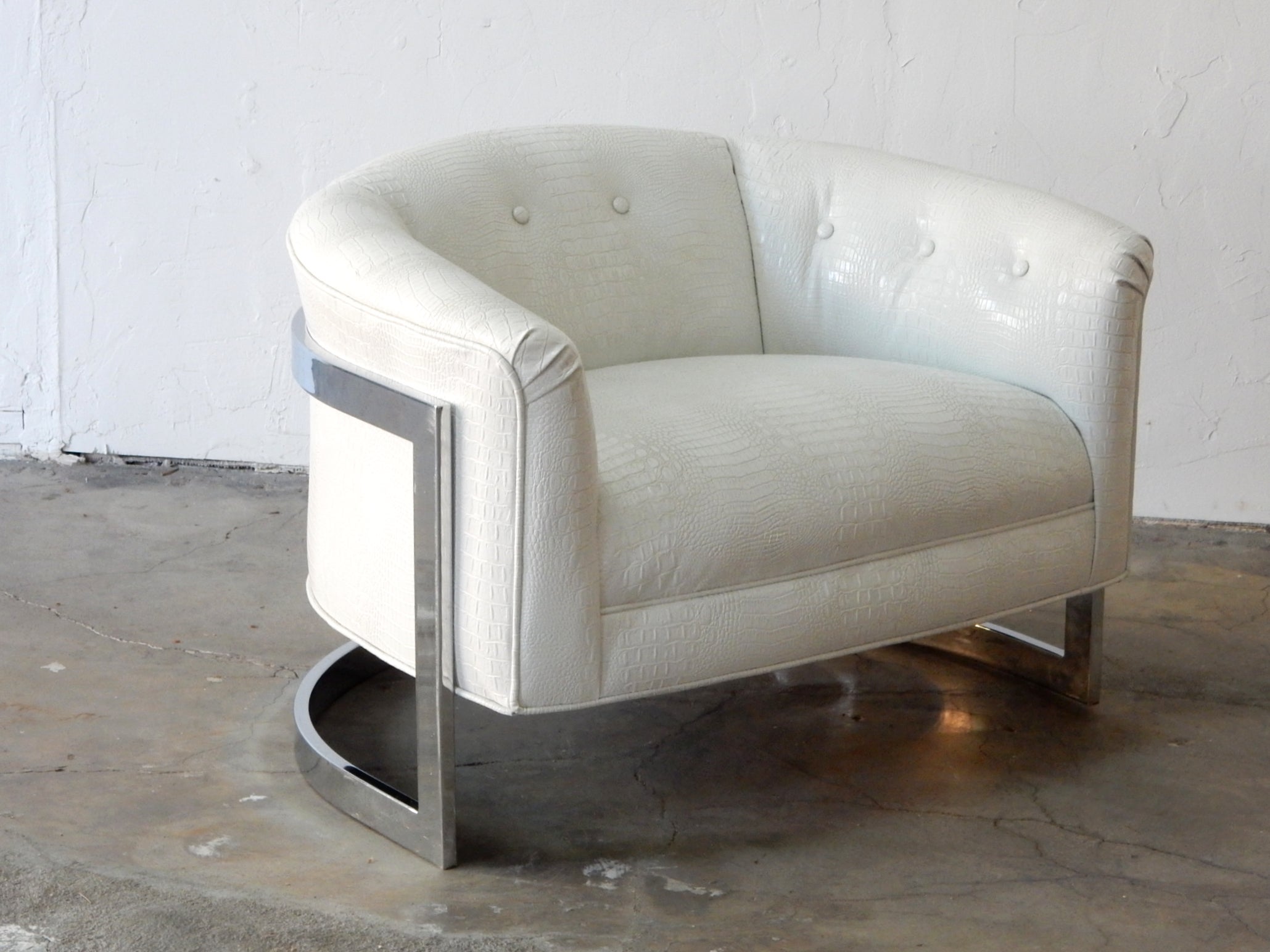Very large floating cantilever tub chair with chromed steel frame dressed in faux vinyl albino alligator hide upholstery.
This fabulous chair is newly upholstered and extra clean.