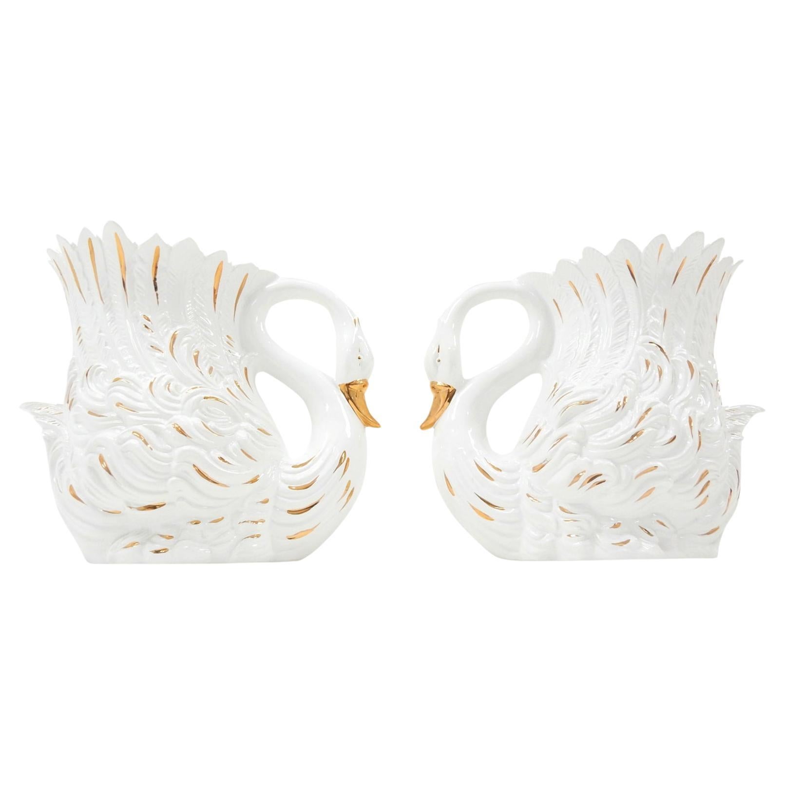 Stunning pair of vintage ceramic swan cachepots. Creamy white glaze with 24-karat gold accents.
Large, life-size pieces as you can see in photos. They measure 2 feet wide and almost 2 feet tall. 
Both signed Bassano, made in Italy,
circa 1960s.