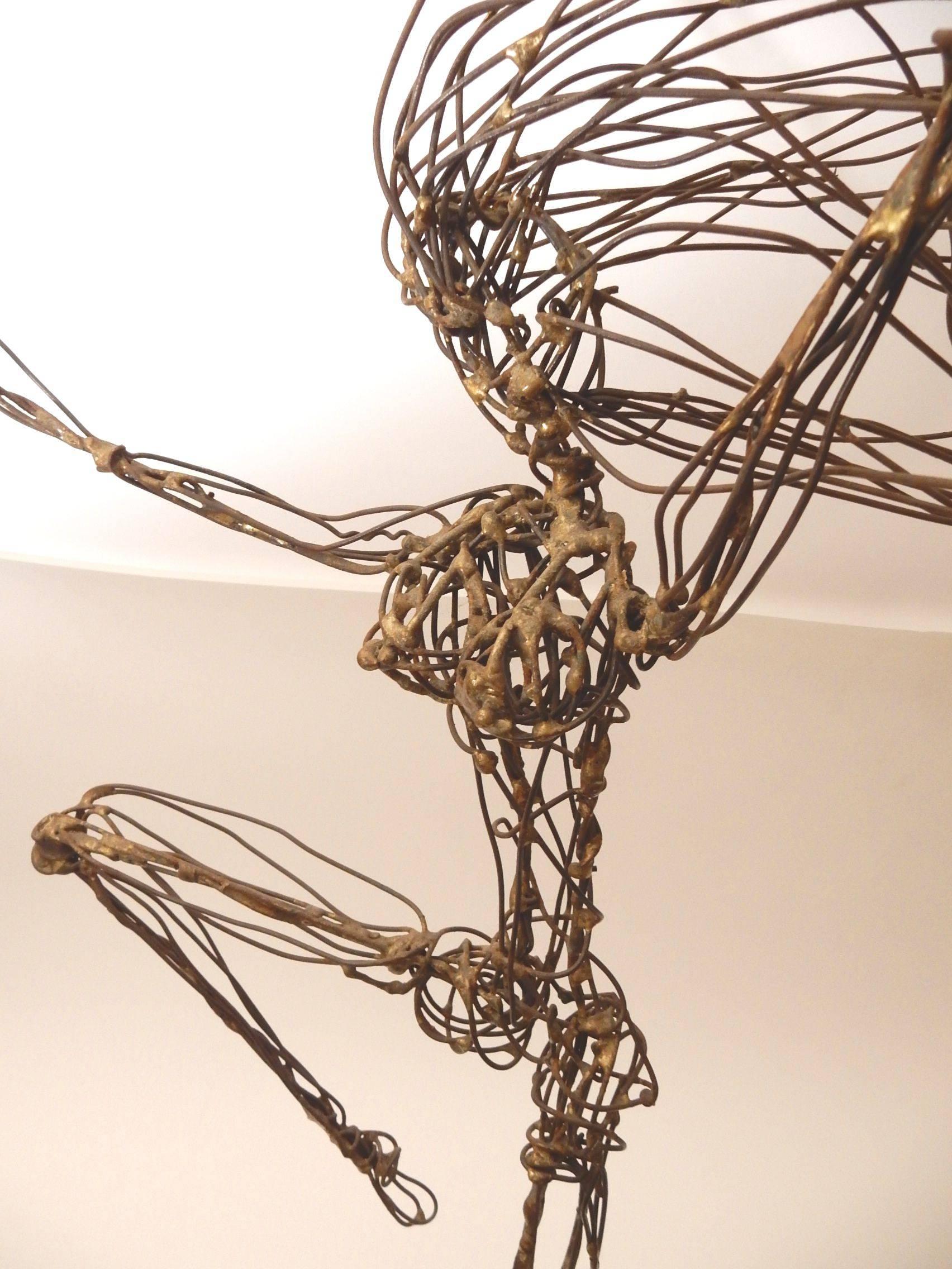 In the manner of Alexander Calder wire sculptures this tall multi layered wire sculpture of a dancer in motion mounted on a wood plinth. Card affixed to base of artist Art Piatt of Canoga Park, CA. Circa 1960's this art sculpture shows great talent