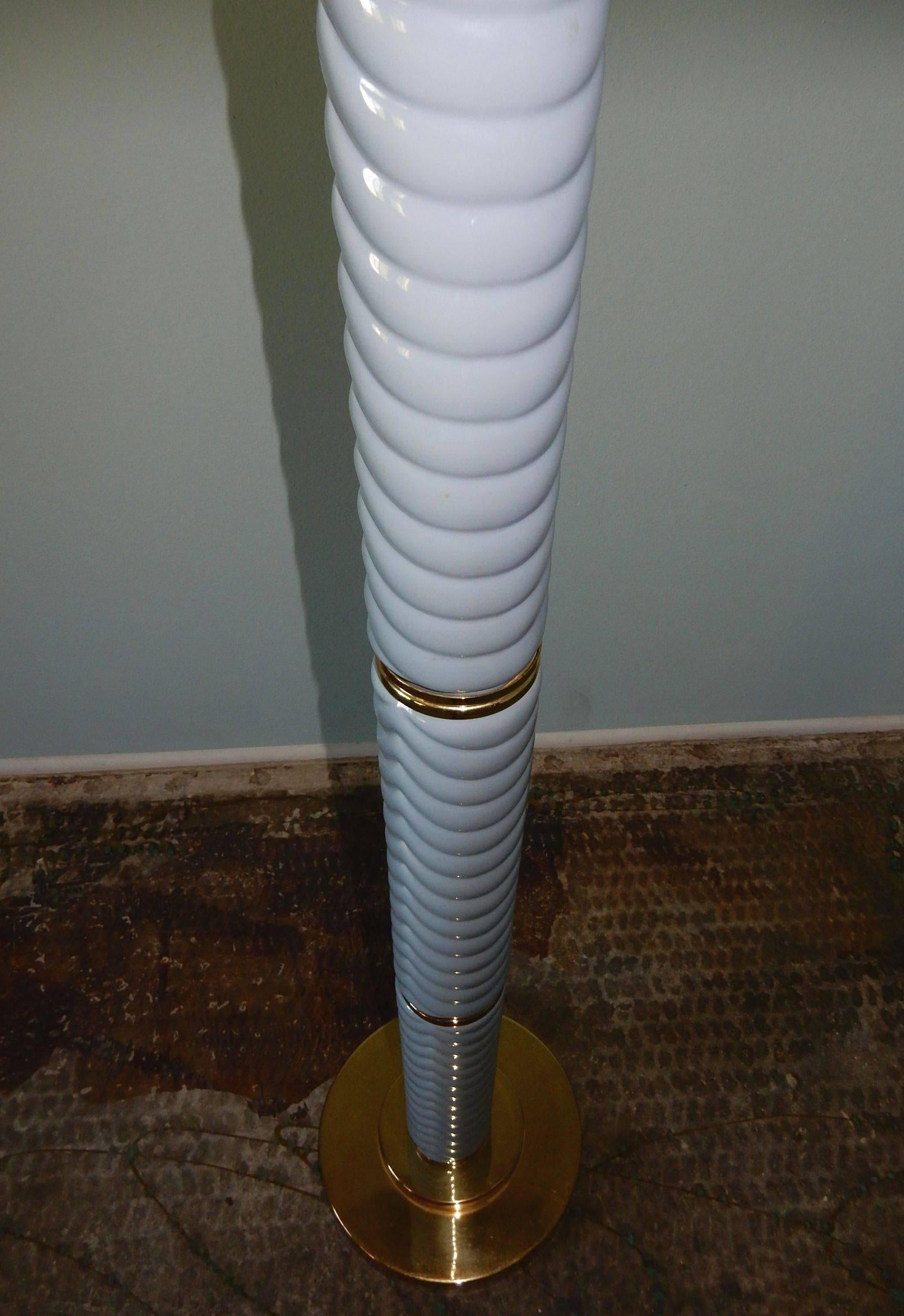 Gorgeous floor lamp designed by Tommaso Barbi. Swirl pattern on powder blue ceramic columns divided by gleaming brass disc on a raised stepped up base.
Very heavy well crafted piece.