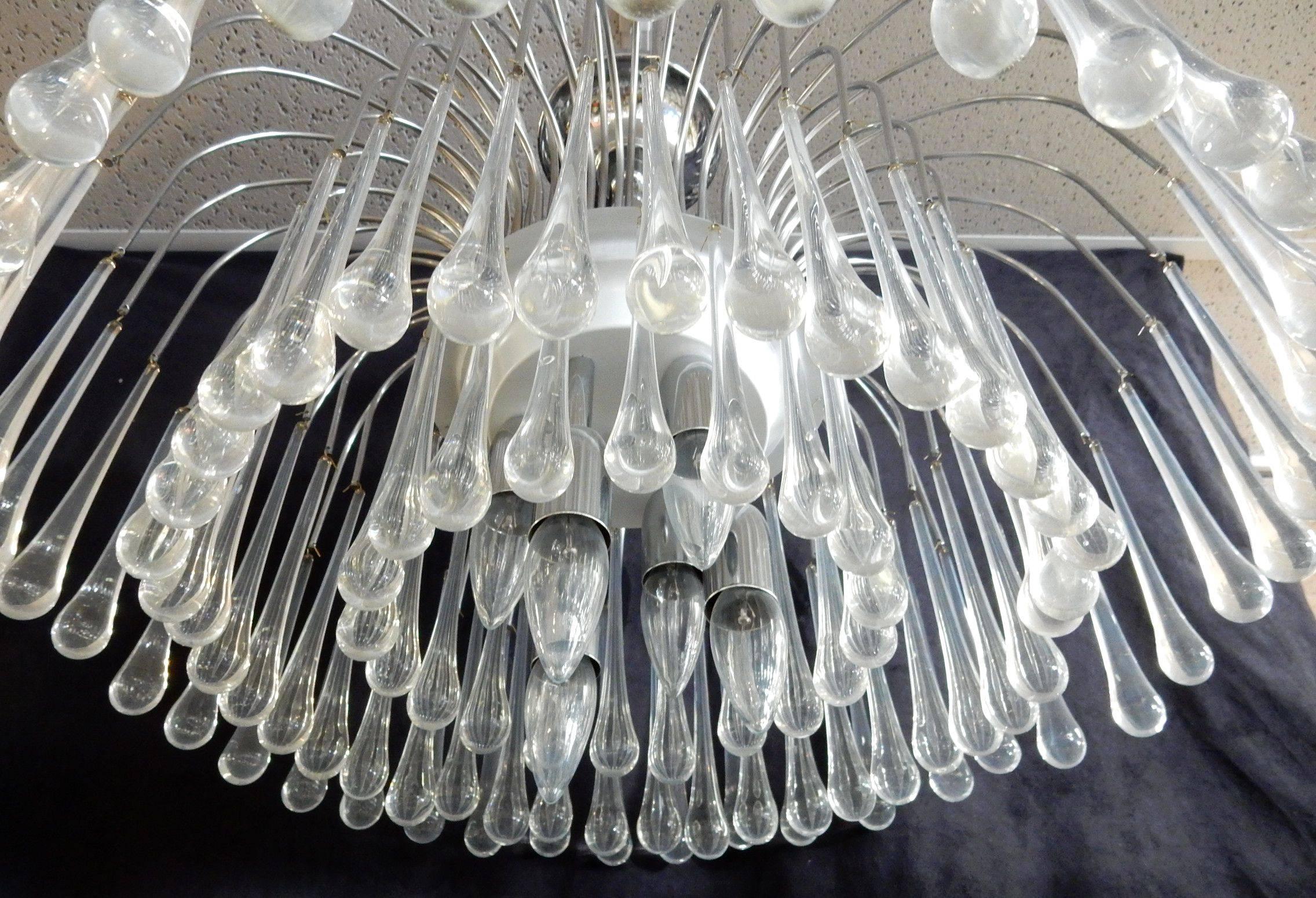 circa 1970's Italian chandelier with 100 long narrow teardrop shape crystals suspended around 5 candle bulbs.
Exceptional piece, nice quality.
