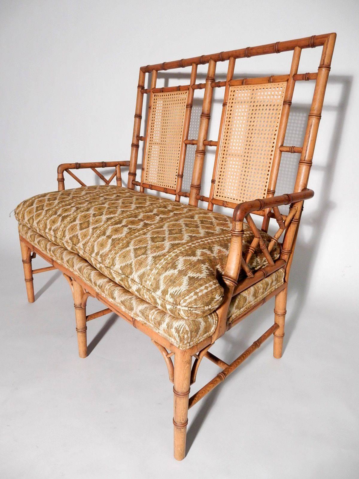 Fabulous vintage settee finely crafted of solid wood carved in a bamboo design with big down filled seat cushion. Exceptional quality piece of furniture.
Not marked by manufacturer.
Excellent condition, solid, with no damage or repairs.