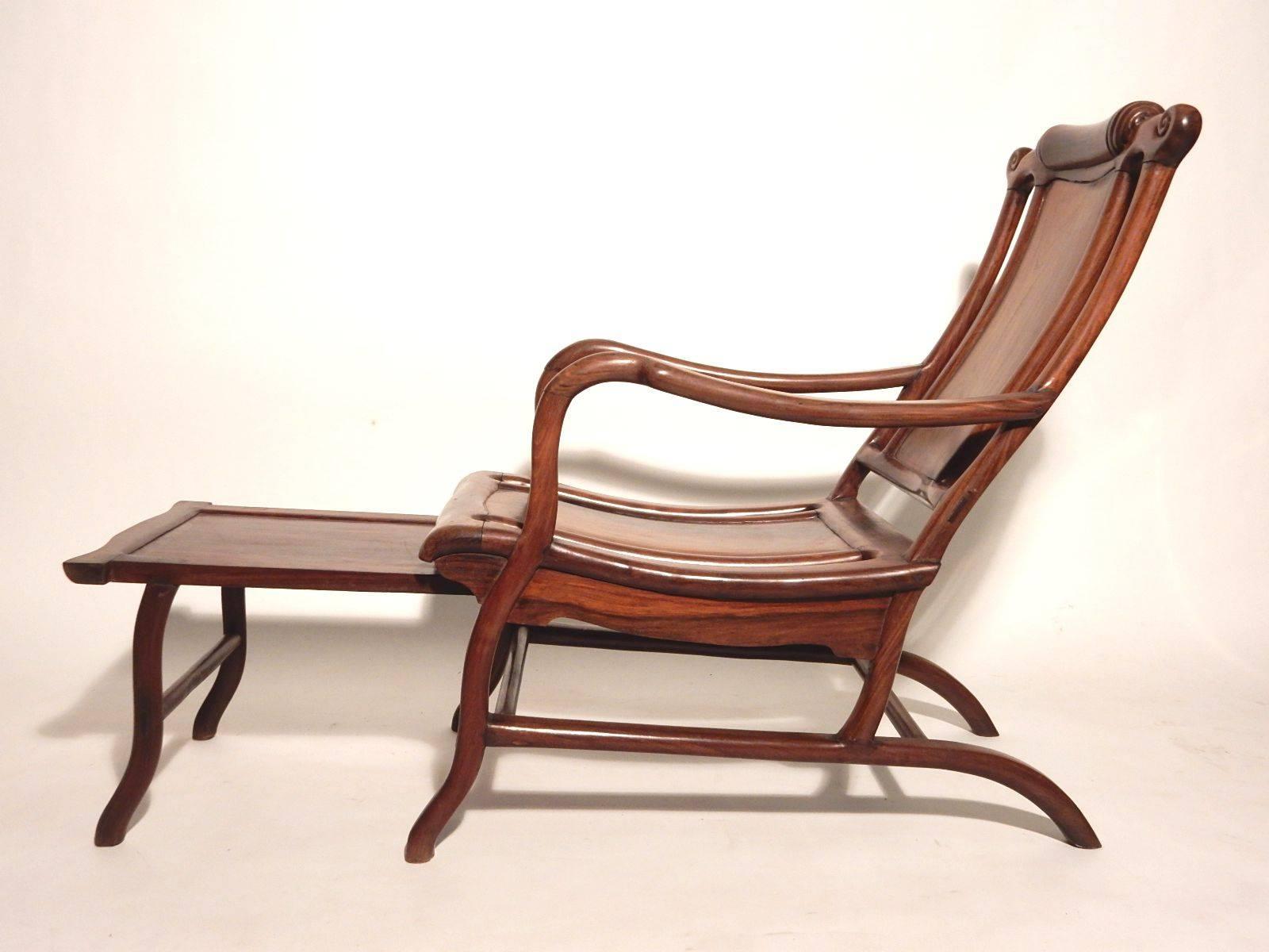 Late 19th century Chinese "Moon Gazing" lounge chair sculpted of solid teak.
Leg extension slides out for a full laid back experience.
Solid chair with no loose joints or movement.
Measures 52" long/deep when open, 32" closed.