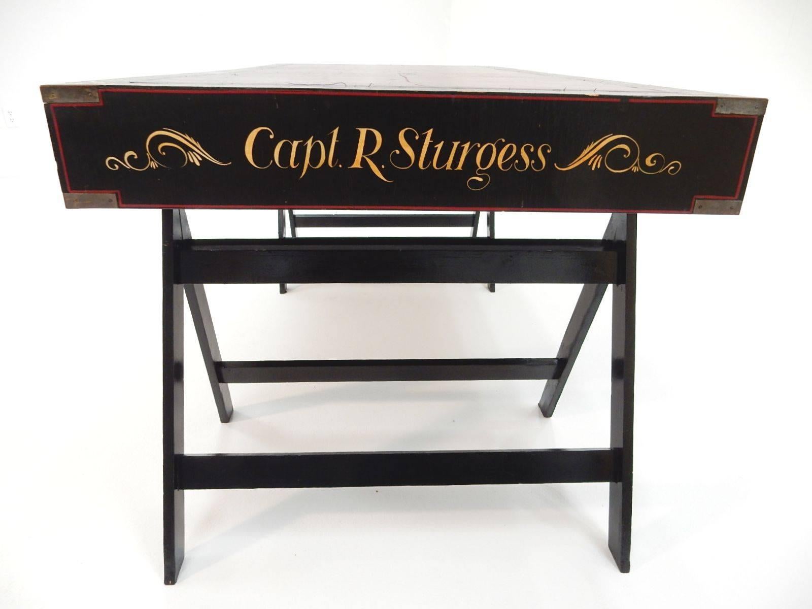 Authentic antique Campaign desk belonging to Captain R. Sturgess, circa early 1900s.
Completely original paint and dyed pigskin leather top on desk.
Three drawers marked 