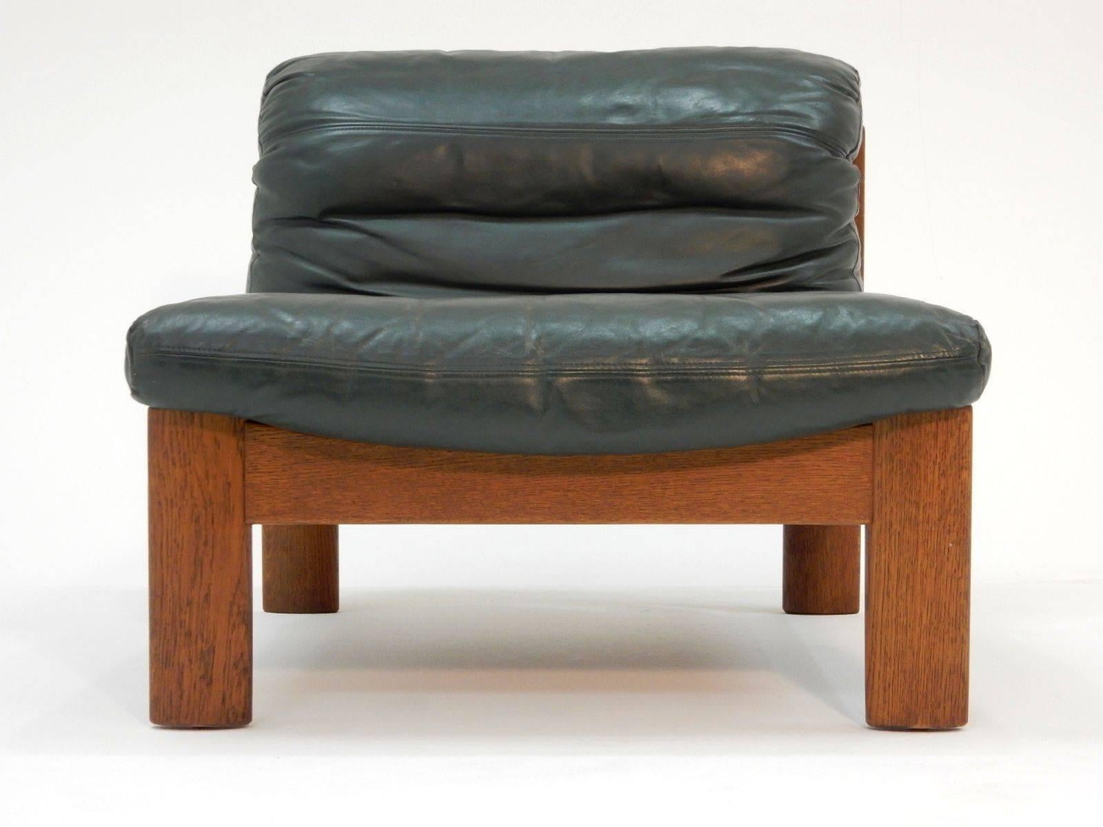 Lounge chairs with dark green leather cushions, circa 1960s.
Thick heavy hardwood frames. In the style of Afra & Tobia Scarpa.
Both are in excellent condition, solid with no repairs.
Super comfortable.