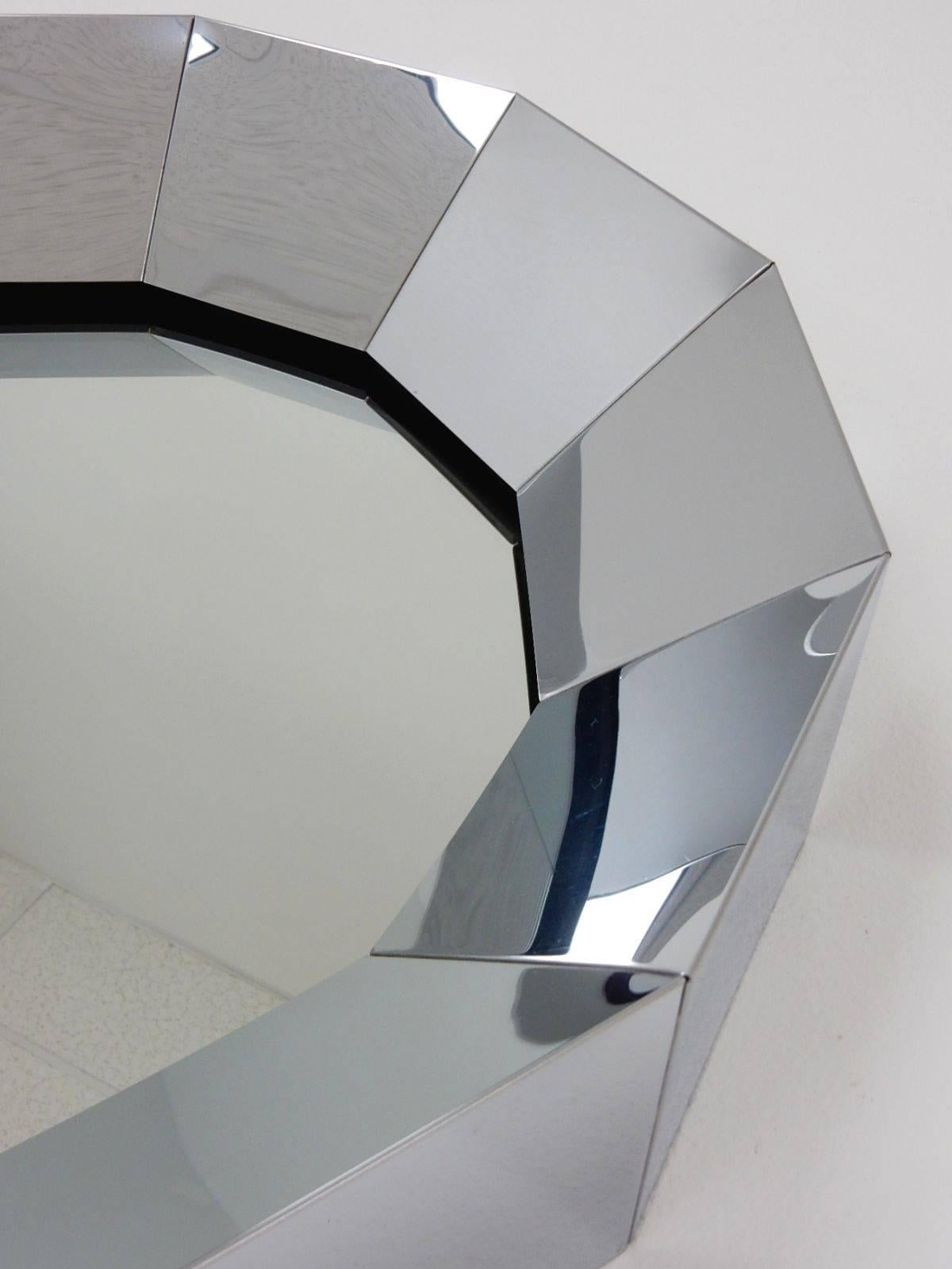 Polished stainless steel wall mirror sculpture by Curtis Jere, circa 1972, signed.
Scalloped edge with inset glass reflect a room beautifully.