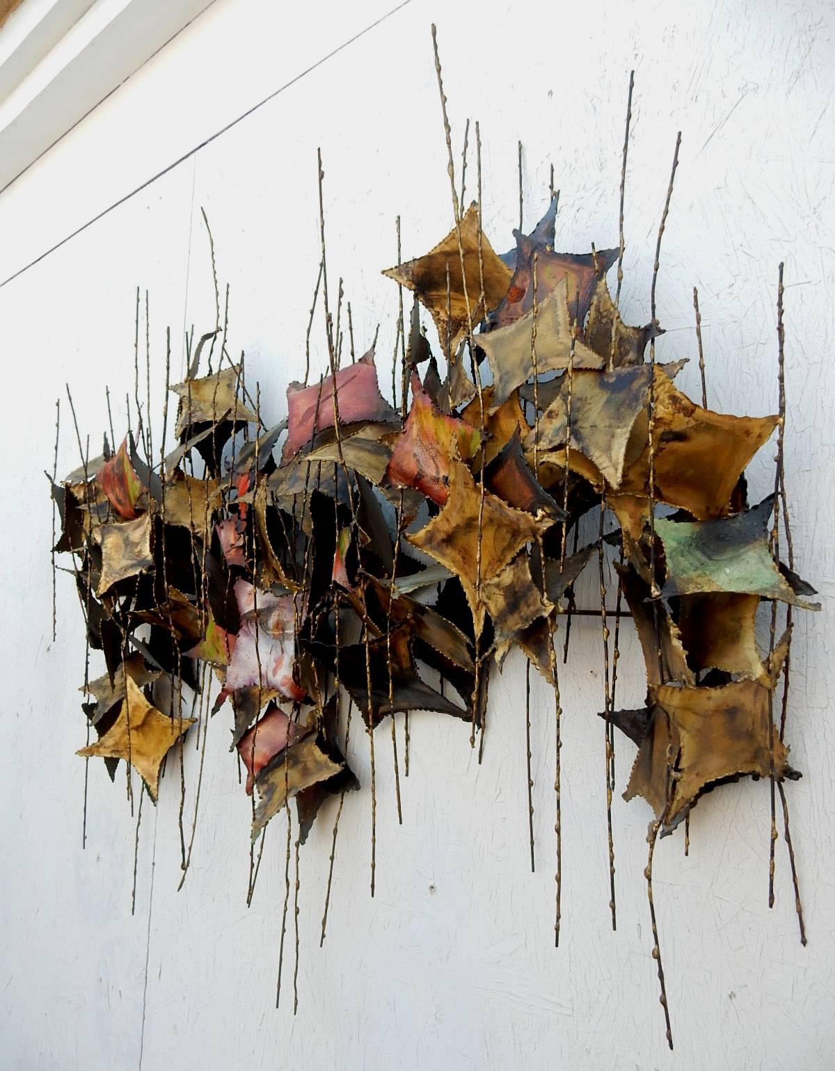 This is a very large, heavily textured wall sculpture consisting of torch cut brass 