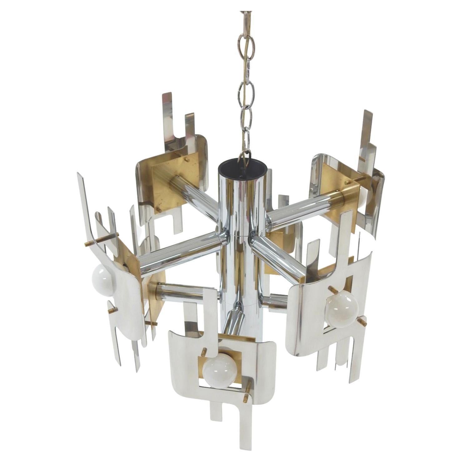 Fantastic sculptural brass, chrome and polished aluminum chandelier designed by Gaetano Sciolari. Eight white 