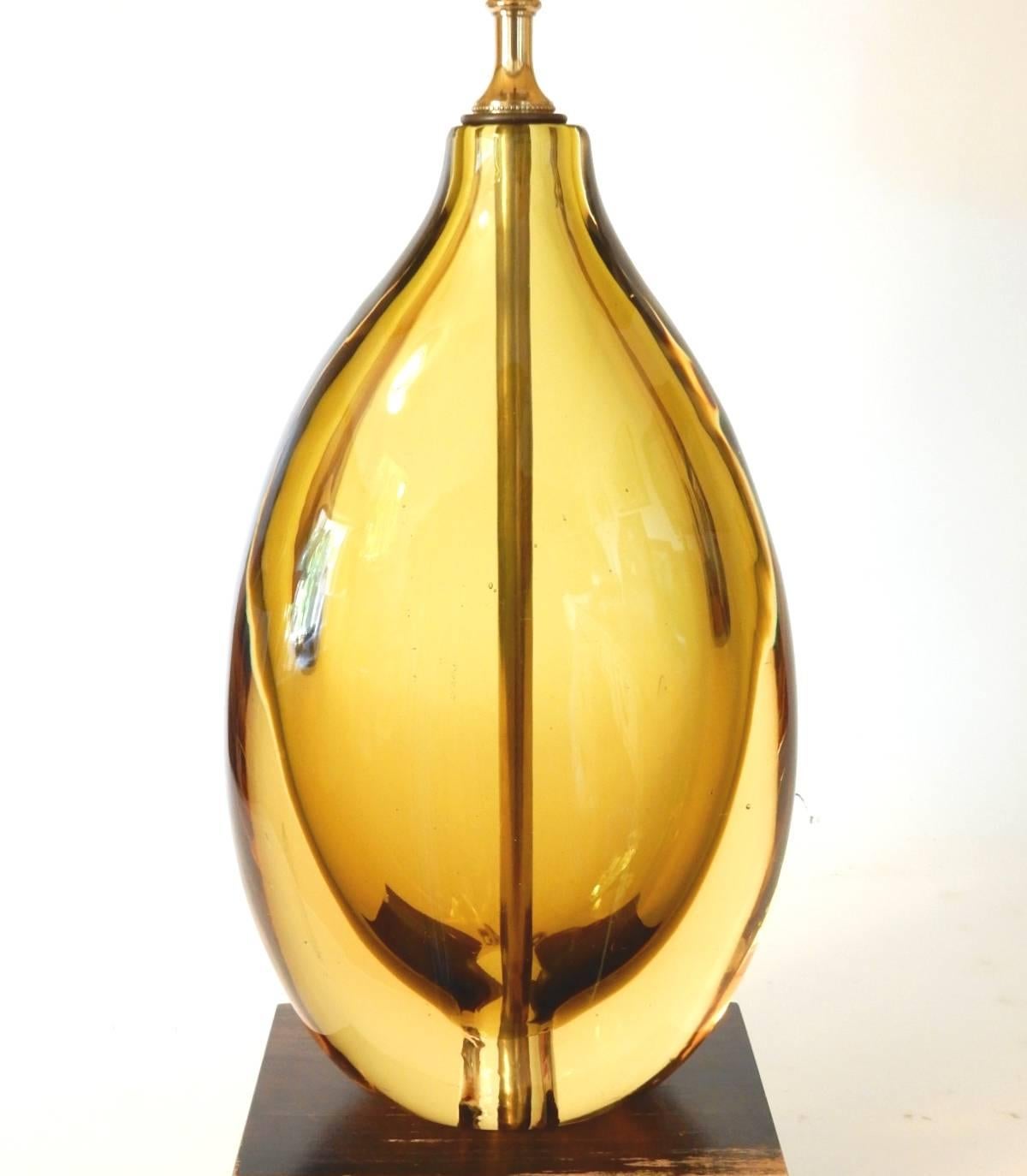 Gorgeous honey green glass vase on a wood base lamp by Flavio Poli, circa 1950s.
This is a large lamp standing 18