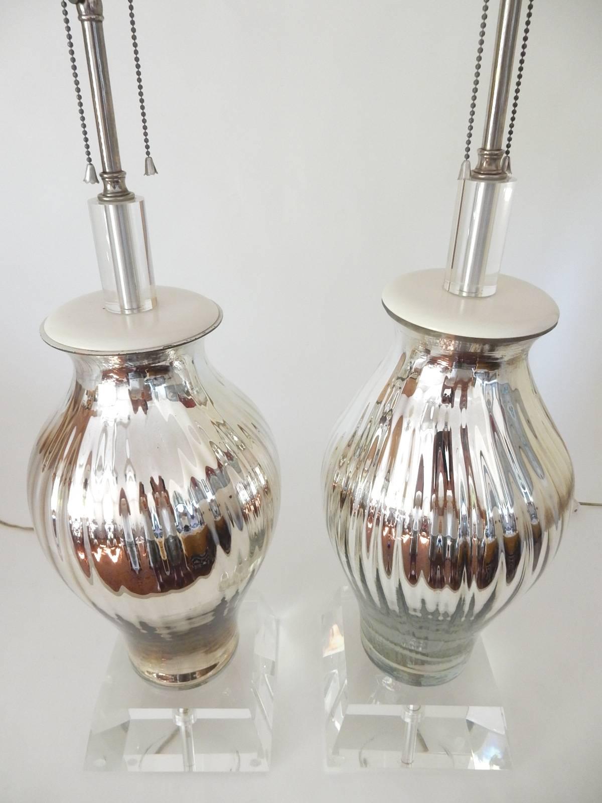 This is an incredible pair of vintage lamps made of handblown swirl art glass vase in gleaming mercury with a thick solid Lucite base and top. Chrome hardware.
Excellent condition with no damage of any kind.