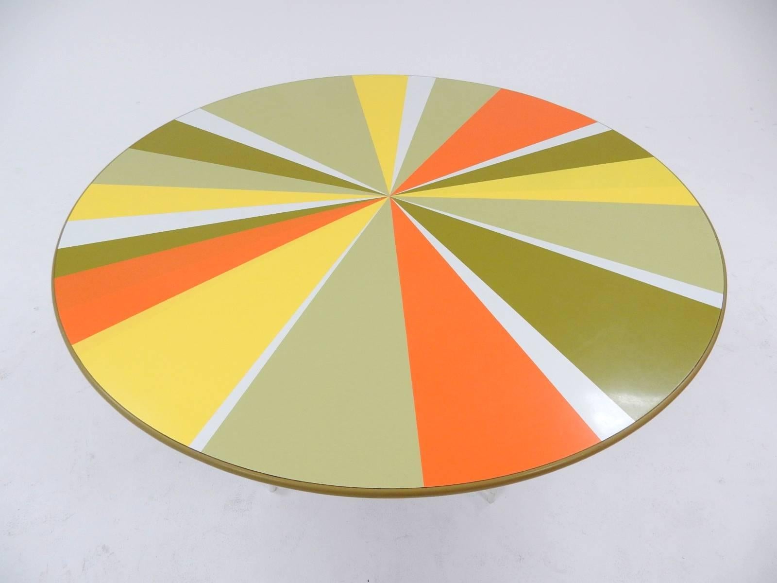 Fabulous rare Peter Pepper Products dining table, circa 1960s. 
Measures: 4 feet wide.
Pinwheel design is part of laminate top, not painted on.
Great bold colors with no fade.