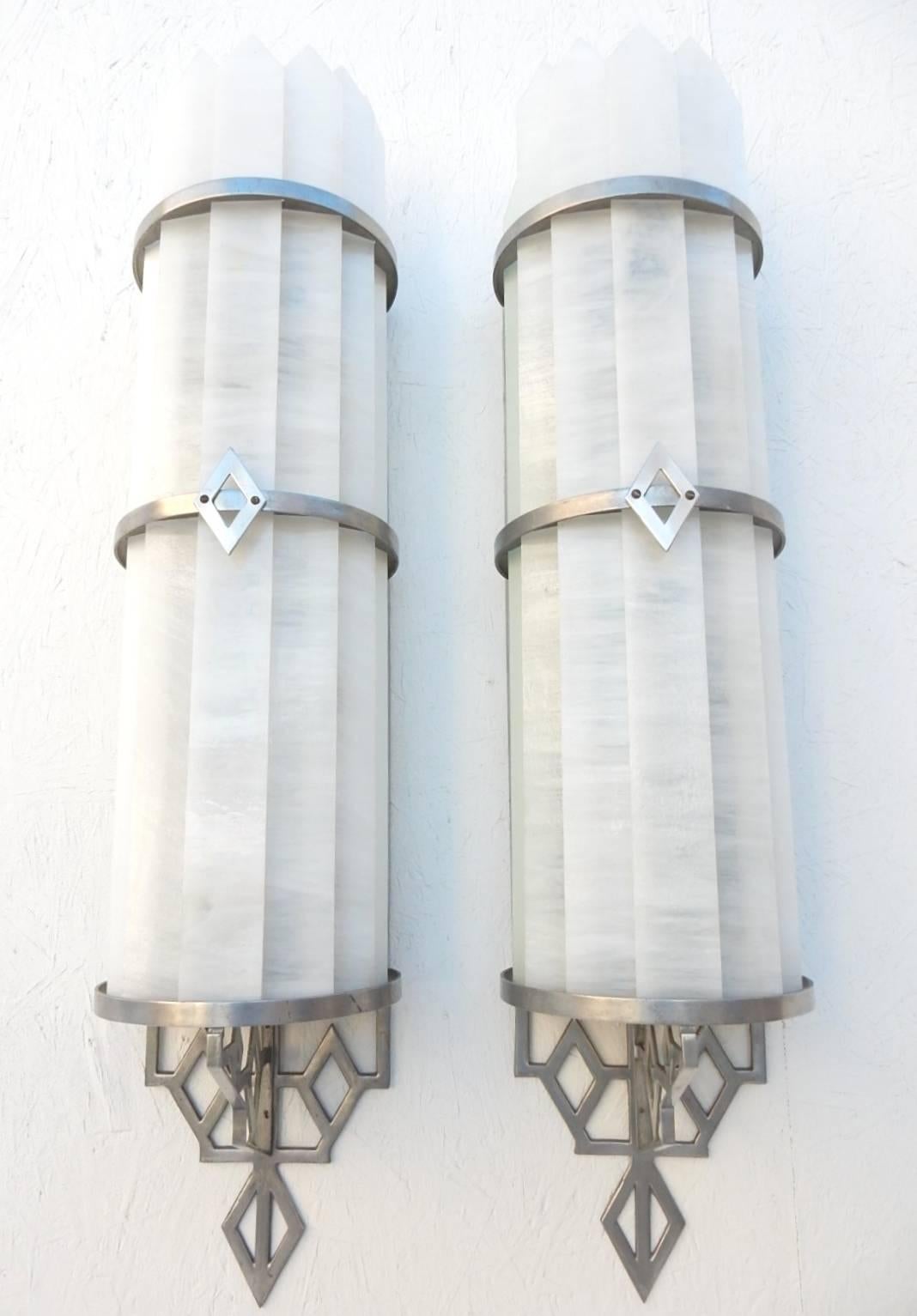 Incredible pair of circa 1930s slag glass and polished aluminum wall lamp sconces from a Los Angeles theater, They measure over 3 feet tall.
Each has ten bulbs and three toggle switches for soft to full bright use.
Shades consist of 9 