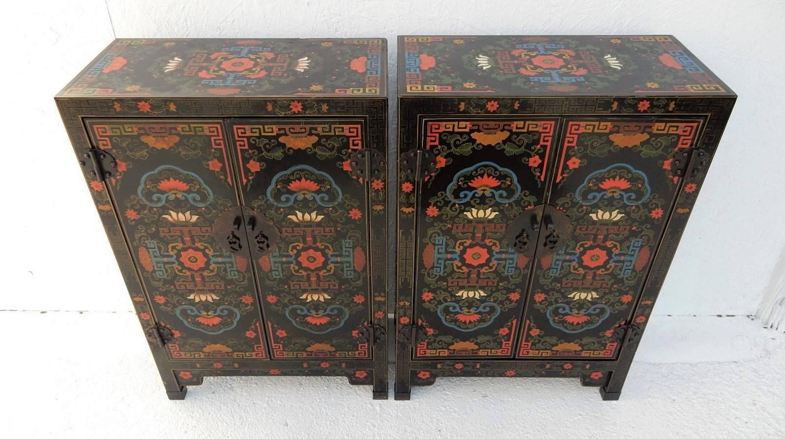 Gorgeous pair of Asian wedding cabinets each hand-painted in beautiful colors over black lacquer.
They are exceptional presentation pieces.
The optical design is organic with lotus flowers, flowers and vines painted on front, sides and