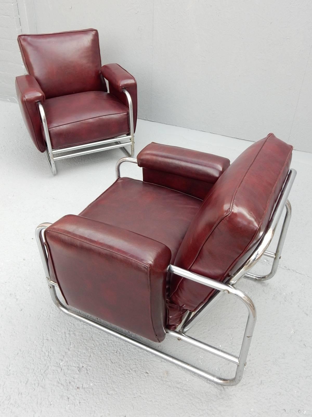 Built like a tank, this pair of lounge chairs are solid, made of chrome plated steel tubing with fat seat, arm and back cushions covered in thick cordovan Naugahyde.
Designer unknown.
Completely original and un-restored. Naugahyde upholstery is