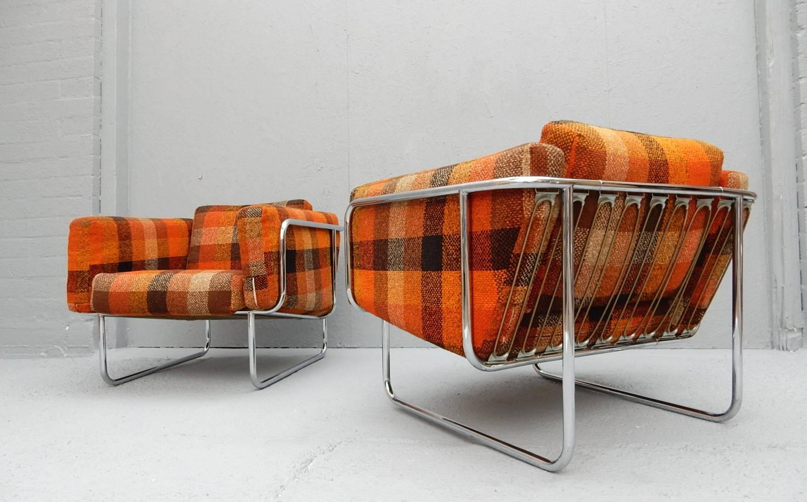 Tubular chrome lounge chairs designed by Hans Eichenberger of Denmark, circa 1960s.
Gorgeous original plaid wool upholstery in bold bright colors.
Very comfortable plush lounge chairs.
   