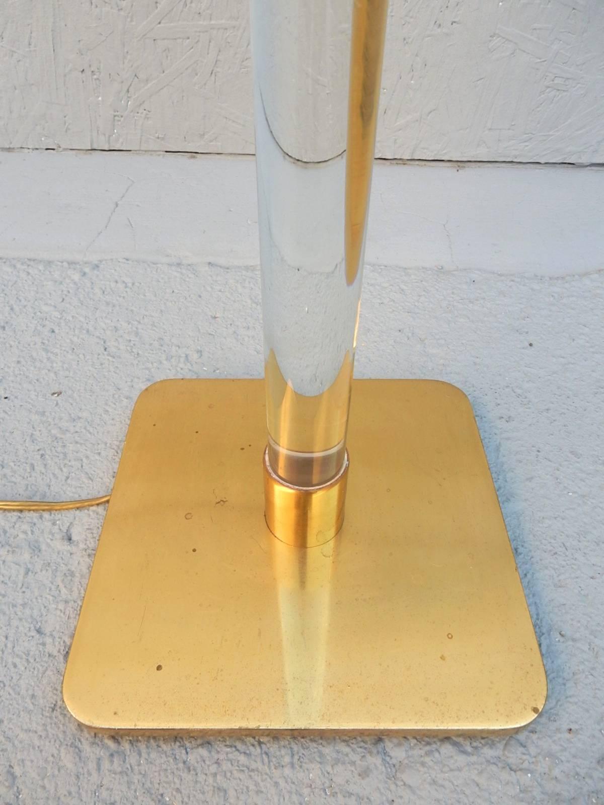 Solid Lucite pole floor lamp by Hansen of New York, circa 1970.
Golden brass hardware and base. Stamped 