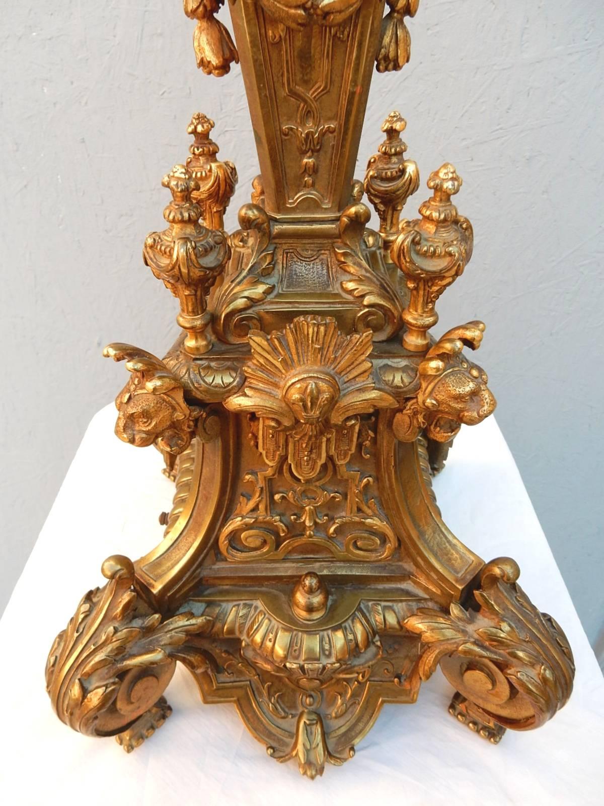 Heavy, solid bronze candelabra covered in gold gilding with amazing aged patina. At over three feet tall it's a statement piece.
Exquisite detail as one would expect from this era.
Masterfully electrified to a seven-candle bulb lamp.
Excellent