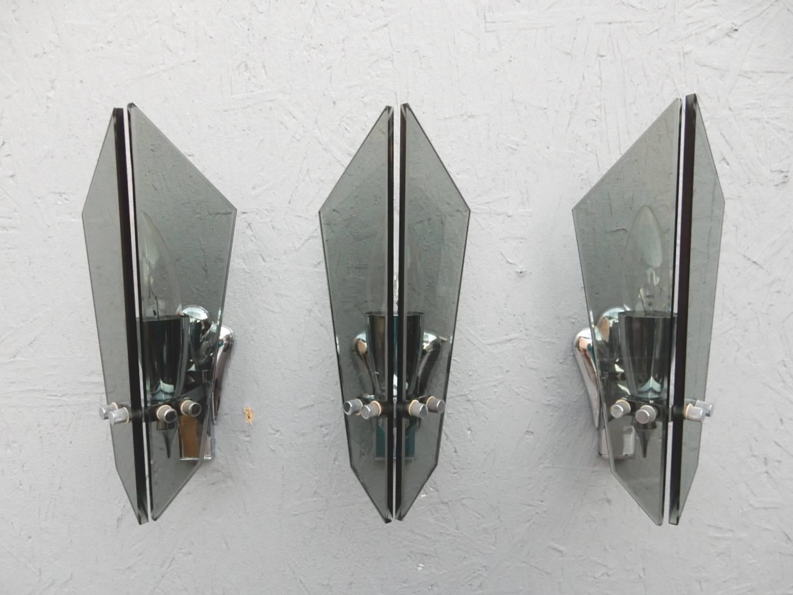 Three attributed Fontana Arte sconces in smoke glass and nickel. European bulb socket. Flush wall mount bracket.
   