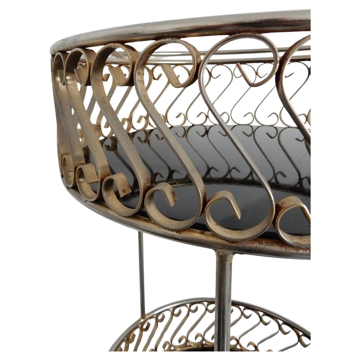 Quality piece of functional art, circa 1950s.
Petite sculpted metalwork bar trolley cart marked.
