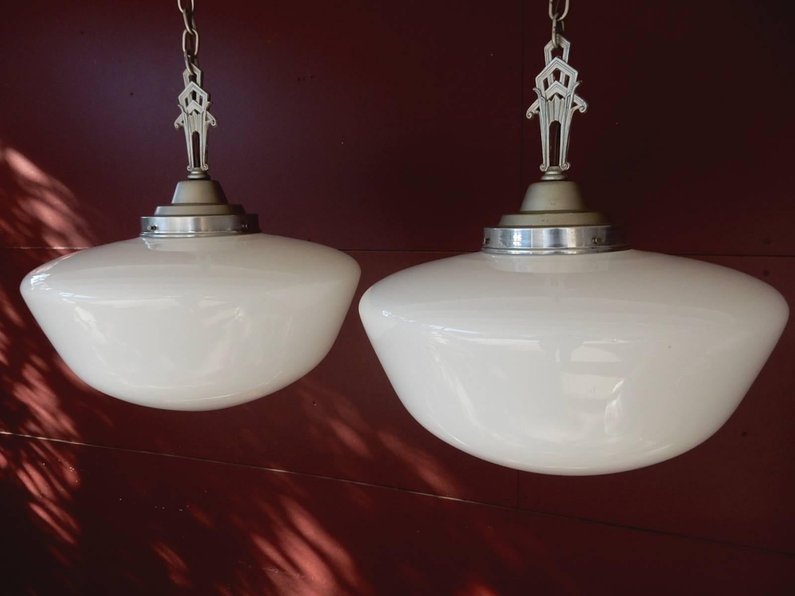 Huge half round hand spun thin milk glass pendant lamps.
Art Deco design finial fitter cap. Amazing glow from antique milk glass.
Polished aluminium ceiling cap and fitter. Measures: 54" drop from ceiling. Each takes a single standard