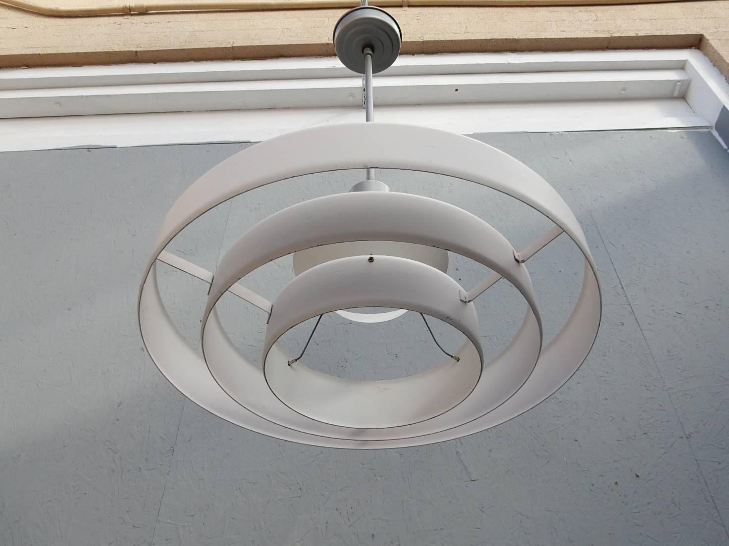 Classic Industrial Mid-Century pendant lamp designed by Kurt Versen circa 1950s. Three ring with bulb shade. Metallic nickel down rod and ceiling cap and putty white rings. 40+ available (un-restored), priced per item. Contact for quantity discount.