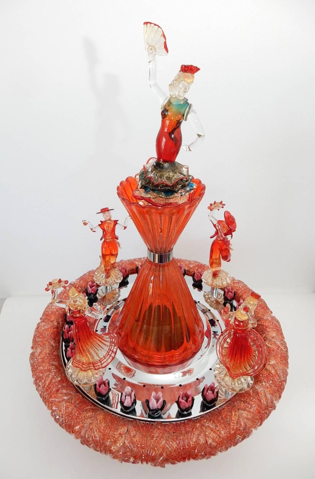 This fountain is a true masterpiece of Murano art glass craftsmanship.
One of a kind ~El baile Flamenco~ work of art done in a mesmerizing orange glass, circa 1960s.
Water spouts from center of each hand formed glass flower while pairs of baile