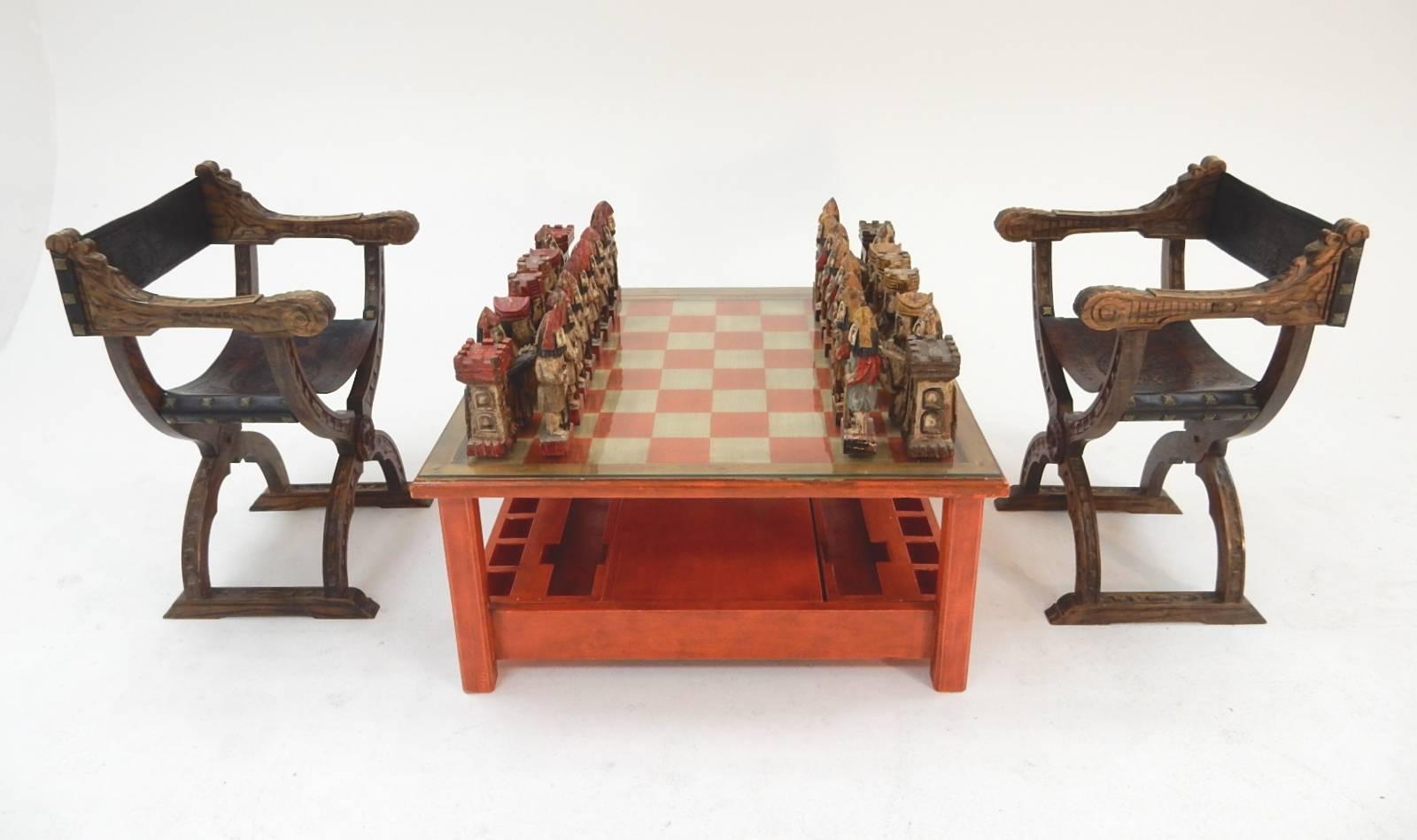 Spectacular Italian sculpted painted chess set and game table. Pieces are carved of hardwood with polychrome features. Each chess piece is a work of art.
Pieces stand 8-11 inch tall. They fit neatly into slotted pull-out drawers on each side. Table