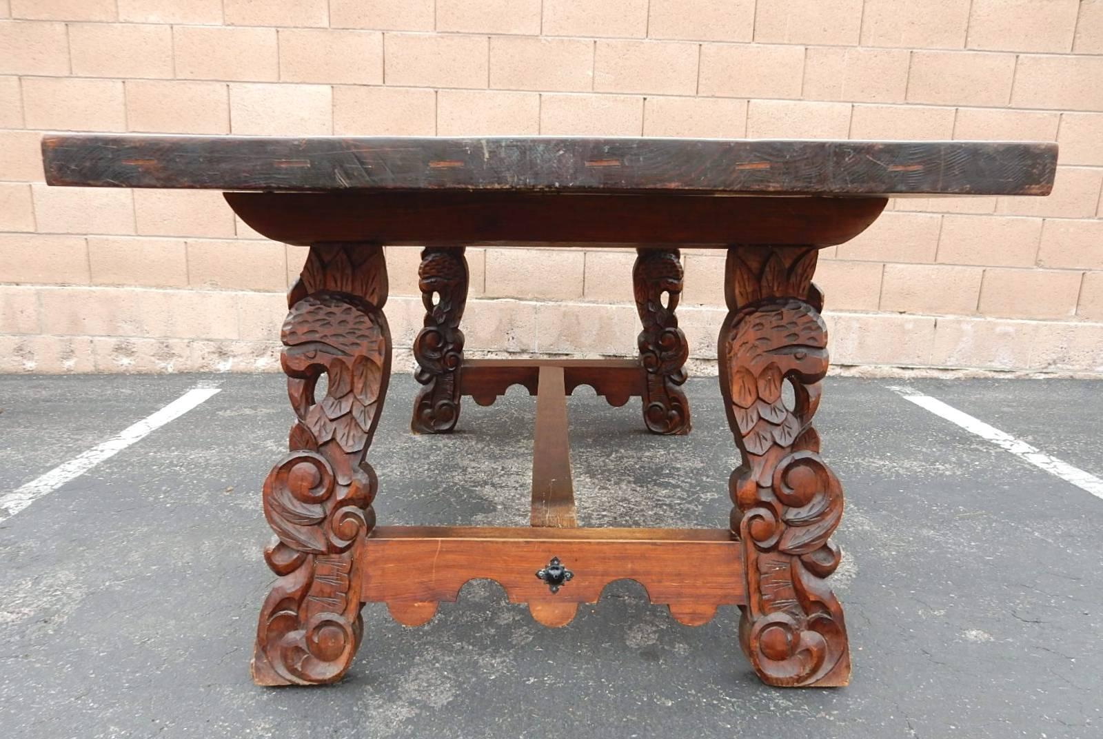 Spanish Colonial Dining Table with Six Elaborate Carved Wood and Leather Chairs In Good Condition In Las Vegas, NV