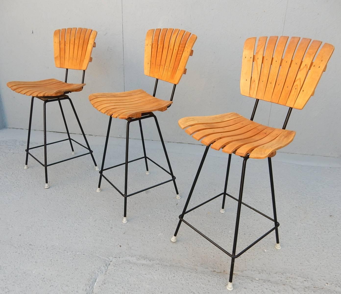 A set of three wood and iron low bar stools designed by Arthur Umanoff for Raymor, circa 1950s.
These three are completely original and in excellent condition with no damage of any kind.
